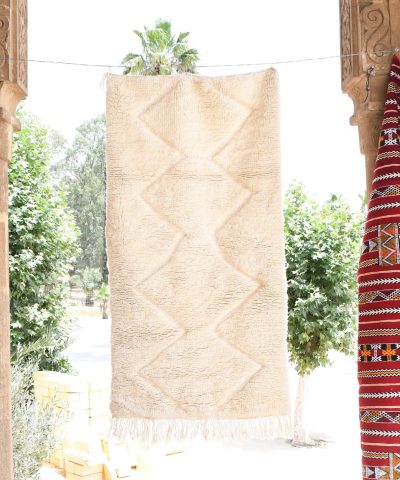 a red and white moroccan rug hanging on a wall. il_fullxfull.6035079244_4oca.jpg