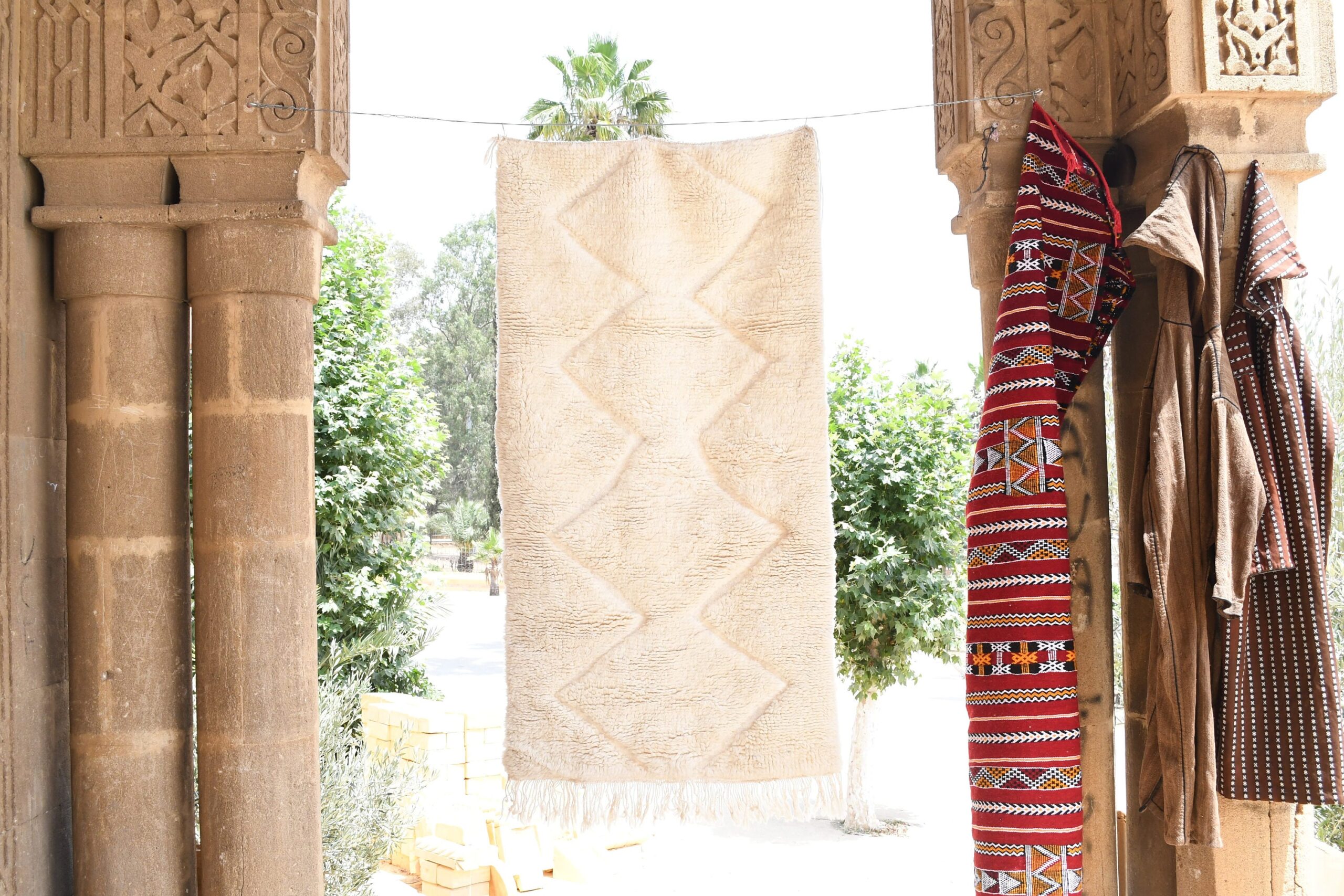 a red and white moroccan rug hanging on a wall. il_fullxfull.6035079244_4oca.jpg
