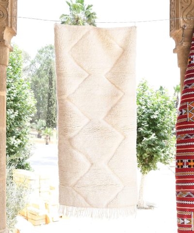 a woman is standing in a doorway with a moroccan rug. il_fullxfull.6035080662_hpkn.jpg