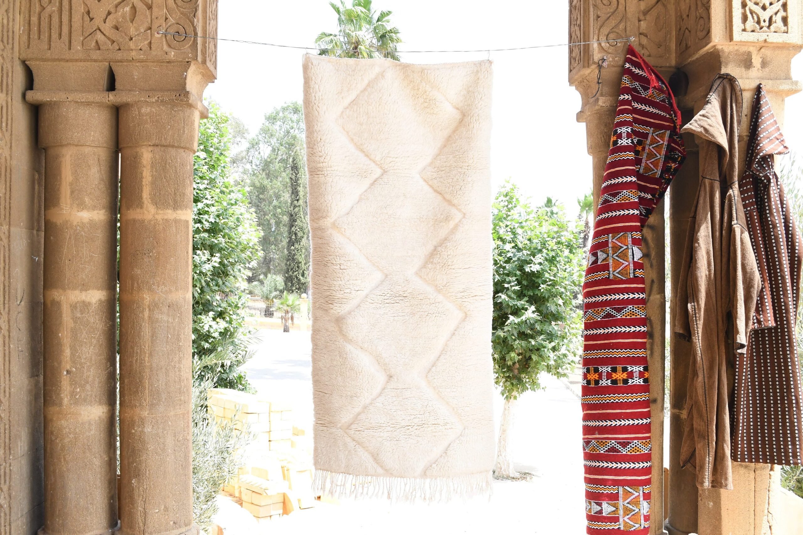 a woman is standing in a doorway with a moroccan rug. il_fullxfull.6035080662_hpkn.jpg