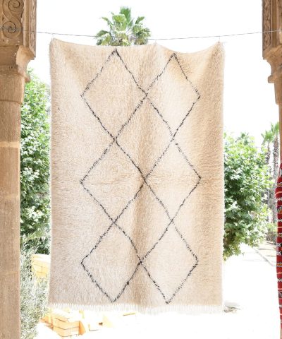 a white rug hanging on a wall. il_fullxfull.6035081926_rmnh.jpg