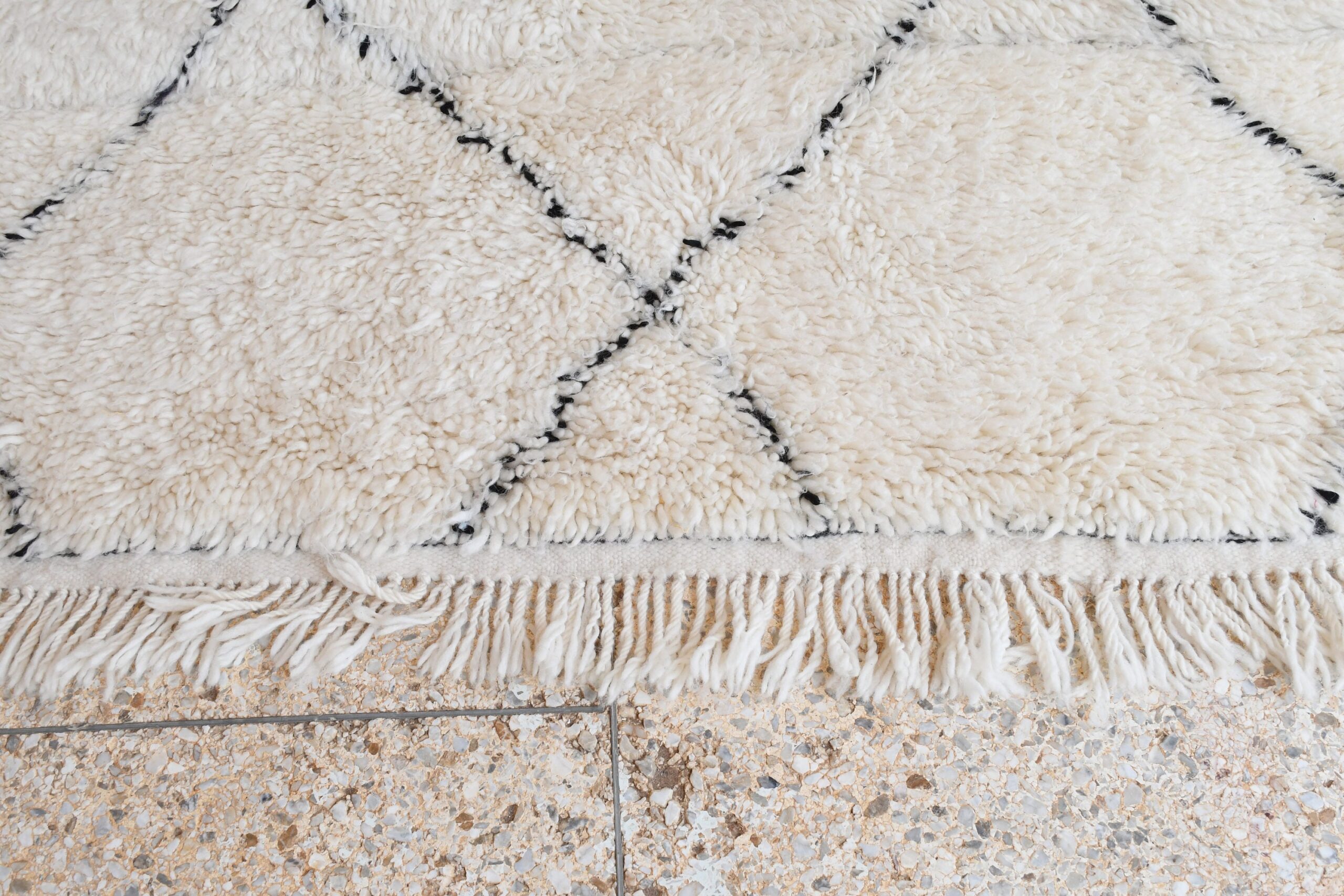 a white rug with black and white designs. il_fullxfull.6035087394_sejg.jpg