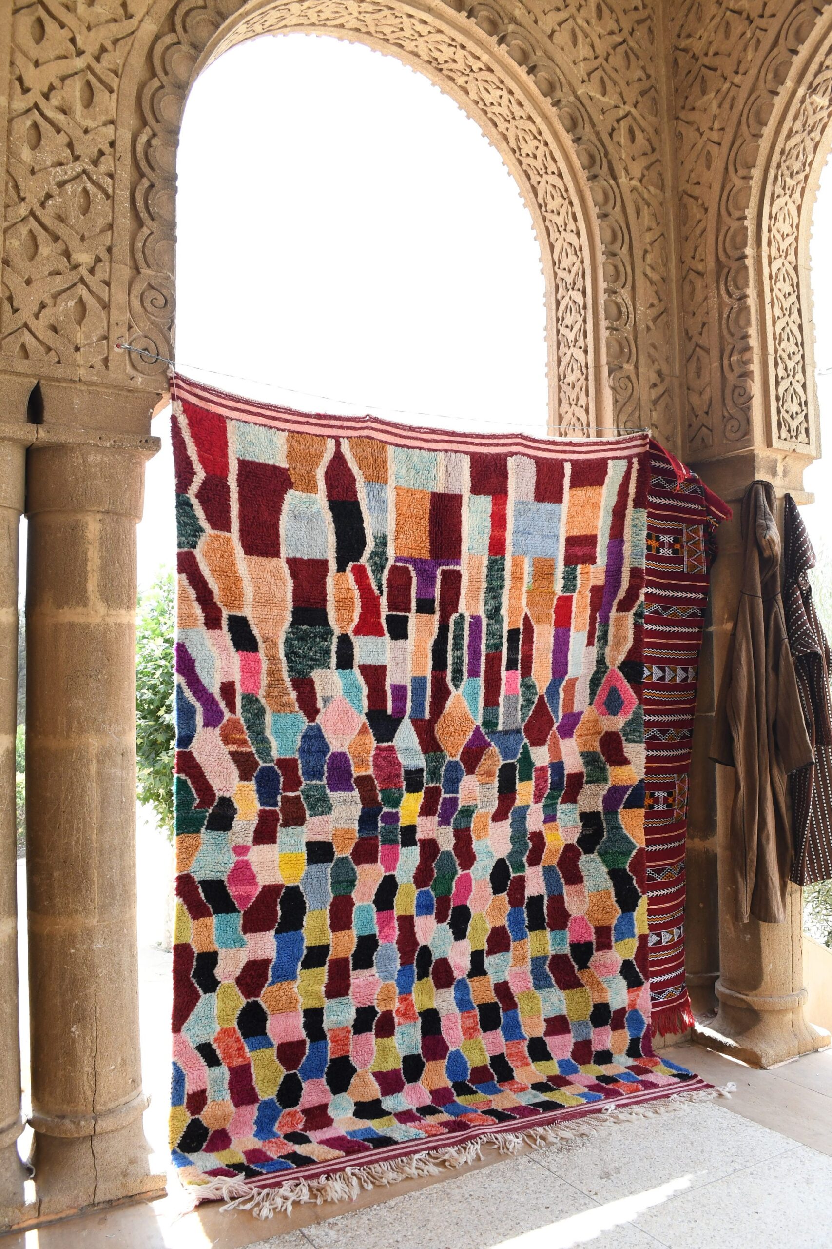 a colorful rug in the courtyard of a house. il_fullxfull.6036478906_qydw.jpg