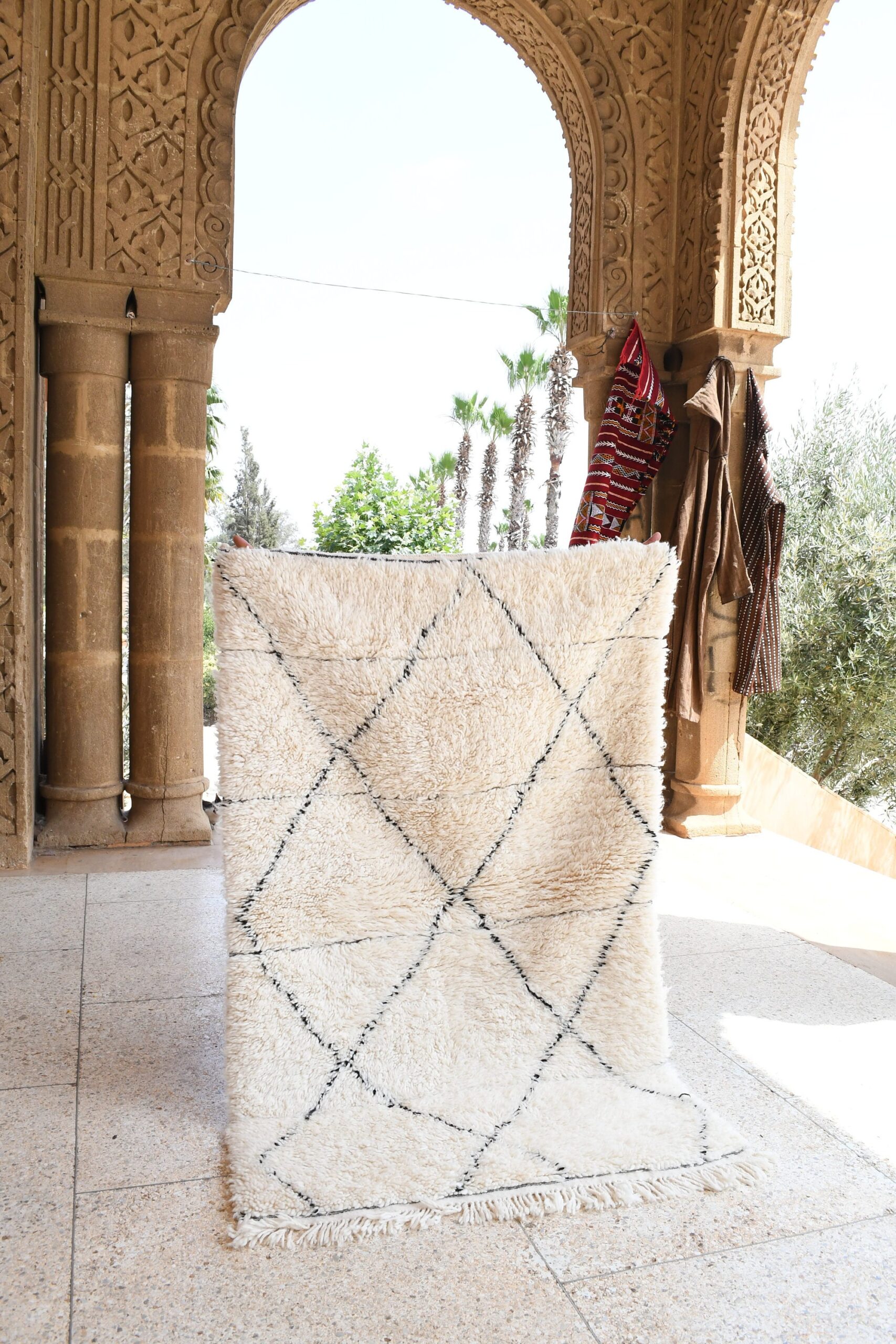 a white rug with a black and white pattern. il_fullxfull.6036490614_kuna.jpg