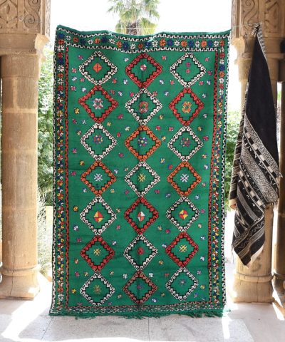 a green and red rug hanging on a wall. il_fullxfull.6065268111_mxy8.jpg