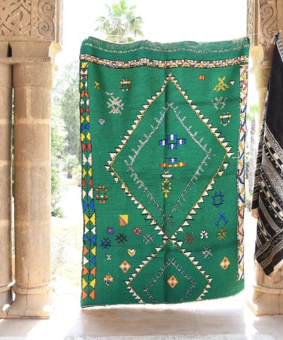 a green rug hanging on a wall. il_fullxfull.6065269233_ixmg.jpg