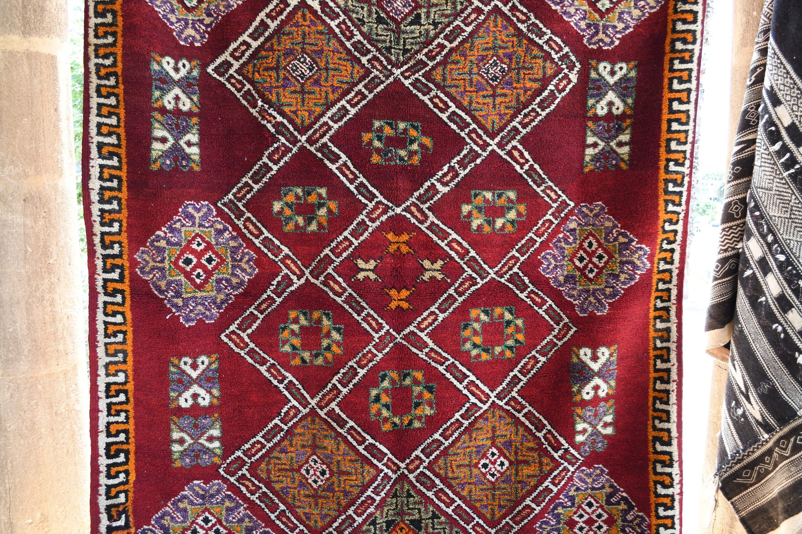 a red rug with geometric designs. il_fullxfull.6065270855_6pjg.jpg