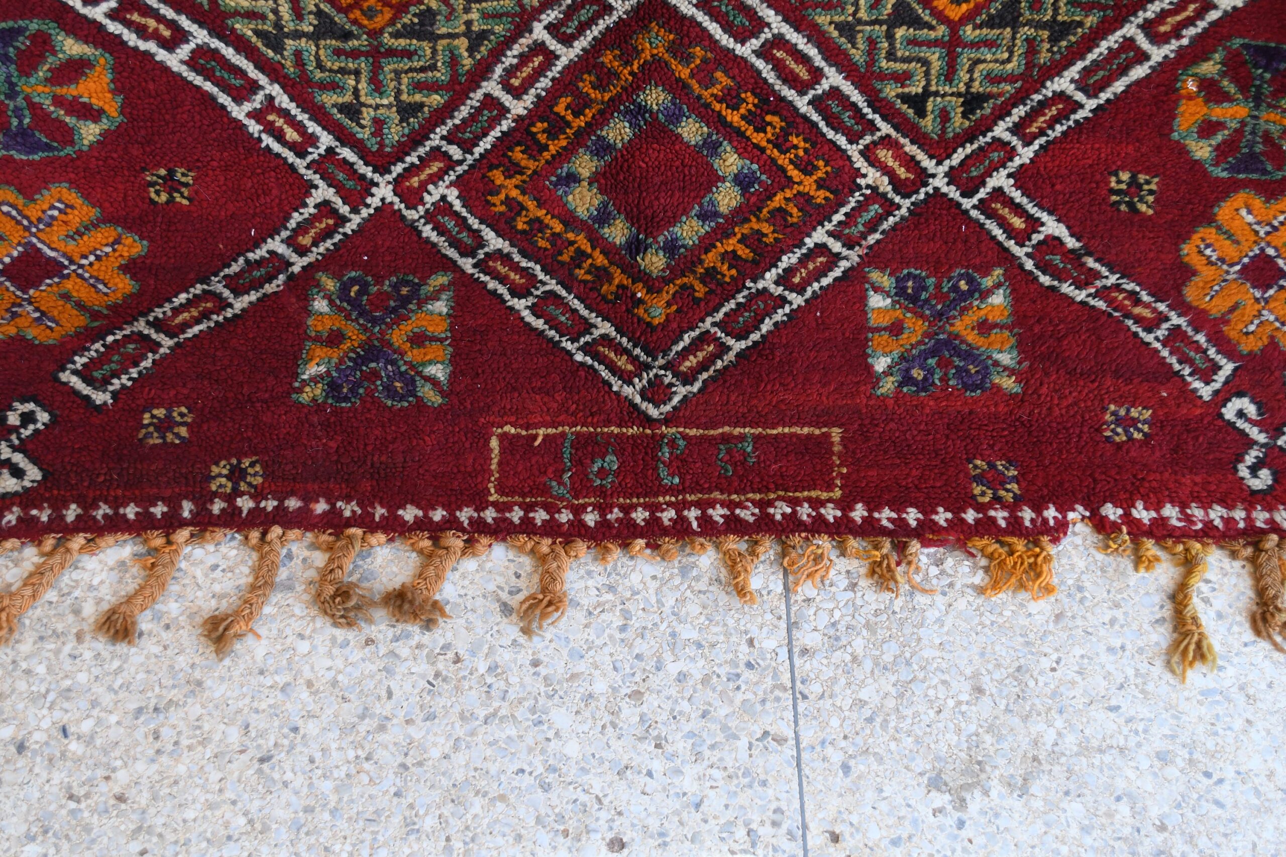 a red rug with a pattern on it. il_fullxfull.6065271097_kv9e.jpg