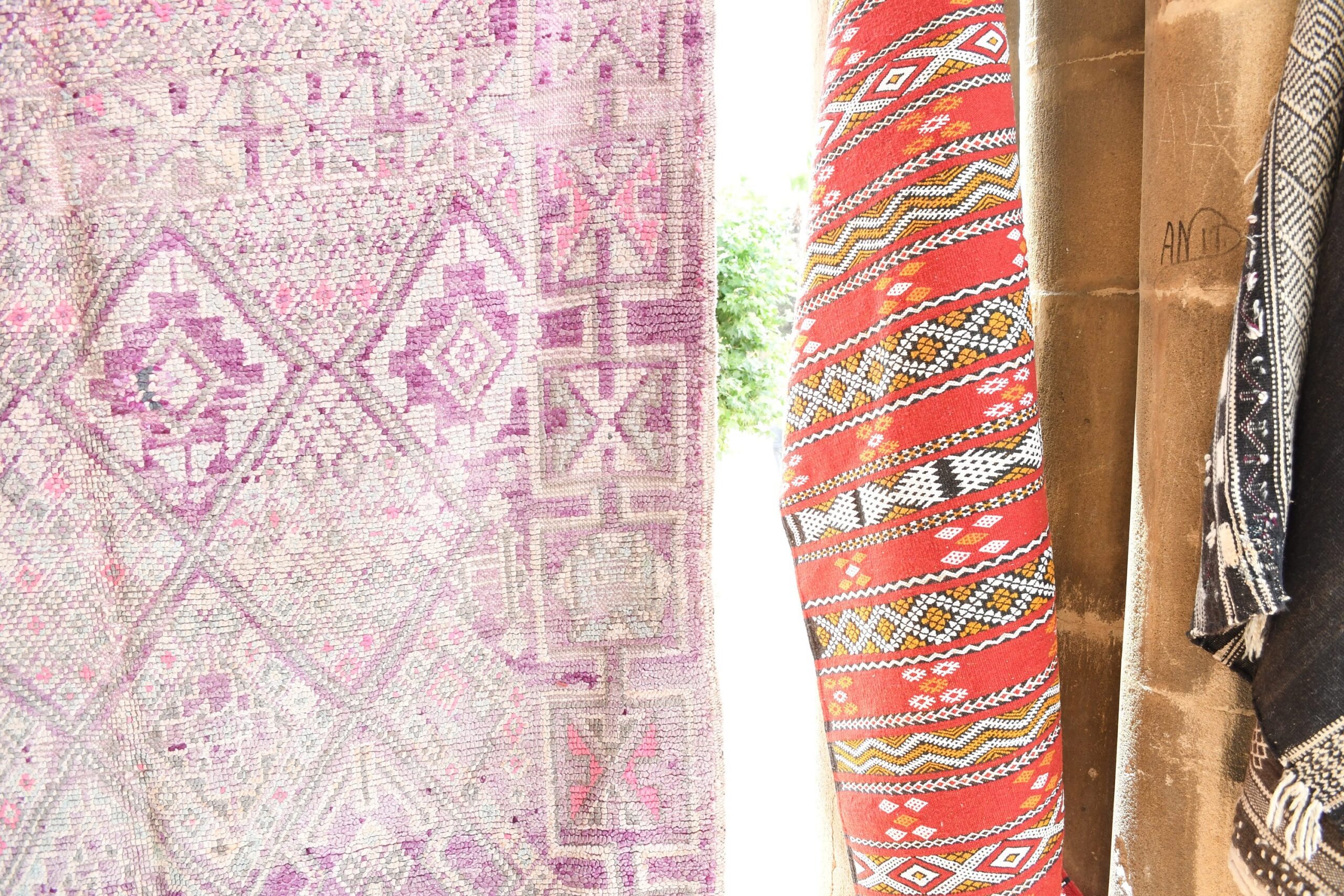 a pile of colorful rugs hanging on a wall. il_fullxfull.6065527633_aq1g.jpg