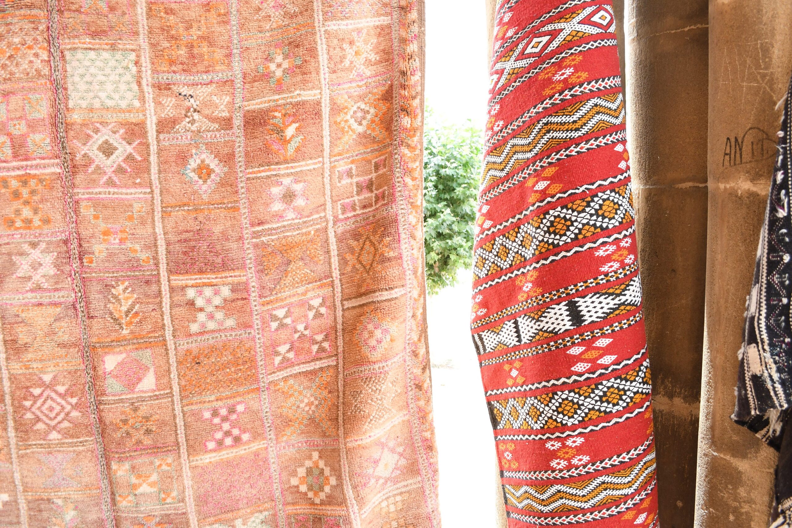 a woman standing next to a wall with a colorful moroccan rug. il_fullxfull.6065530093_9dz5.jpg