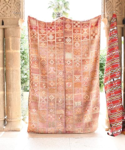 a woman sitting on a bench in front of a doorway. il_fullxfull.6065530453_dqmo.jpg