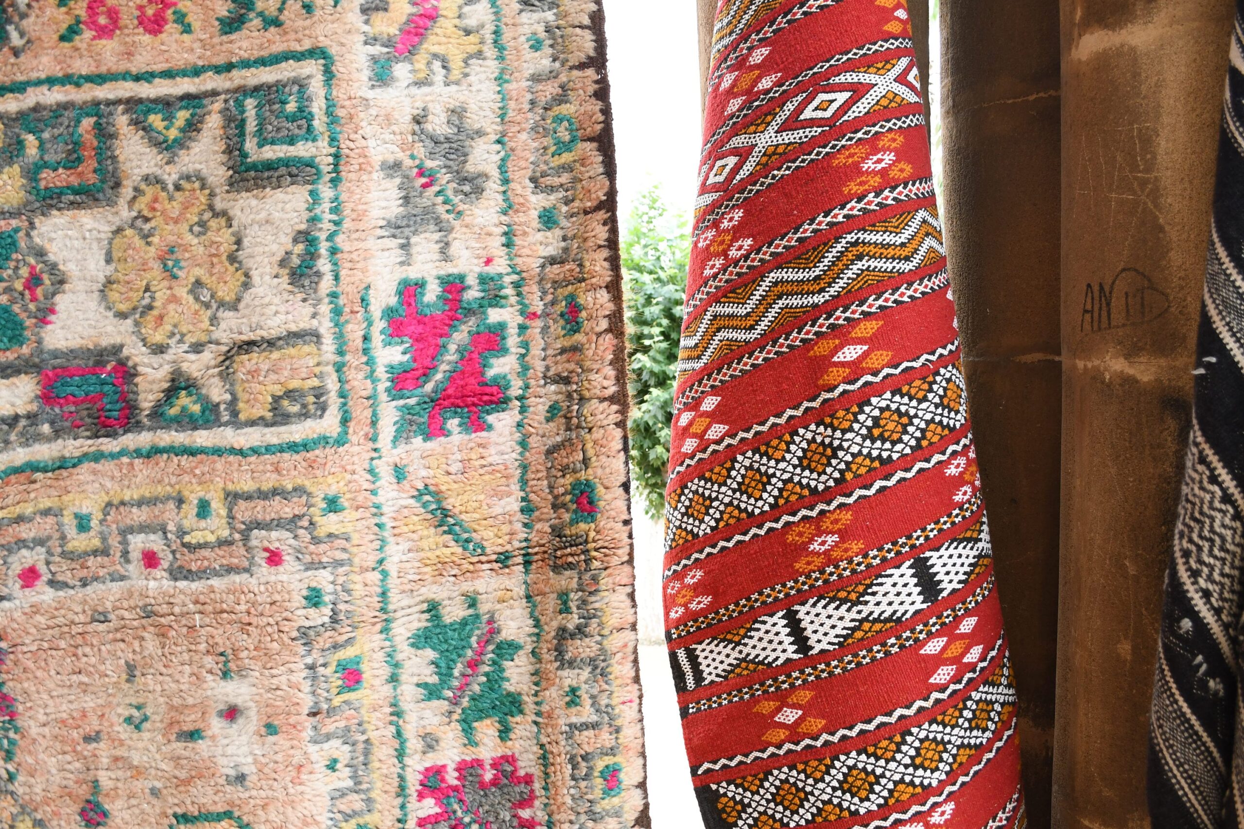 a collection of colorful rugs hanging on a wall. il_fullxfull.6065555083_rhjv.jpg