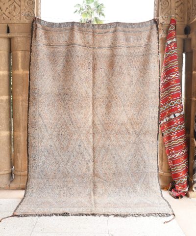 a rug is hanging on a wall in a room. il_fullxfull.6065557769_ryy1.jpg