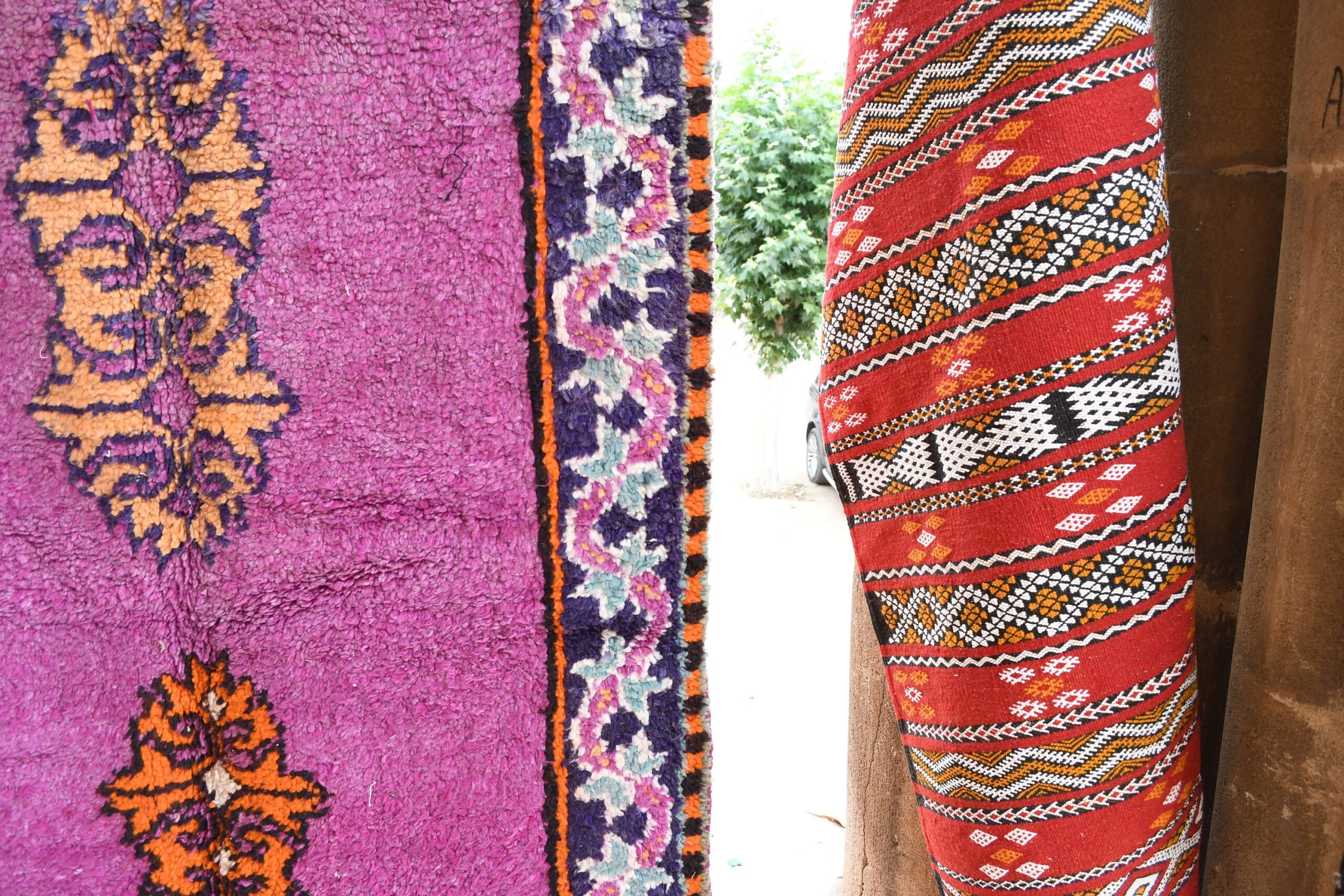 a woman is standing in front of a colorful rug. il_fullxfull.6065566129_e68j.jpg