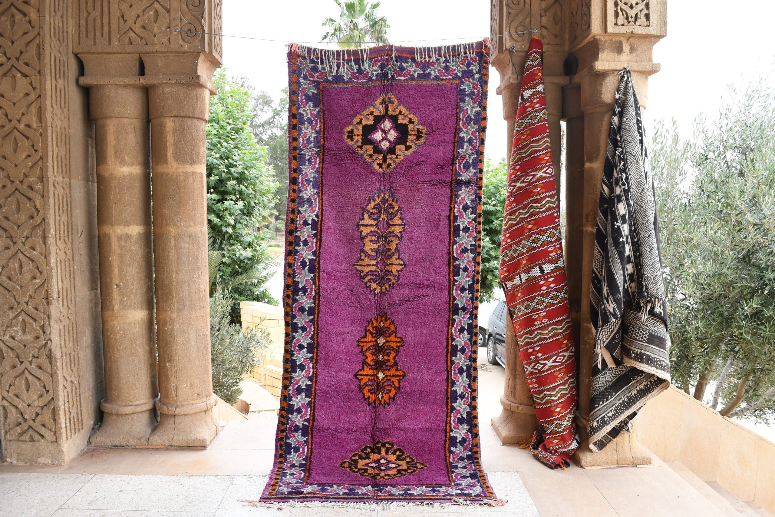 a purple rug with a floral design on it. il_fullxfull.6065566539_66uc.jpg