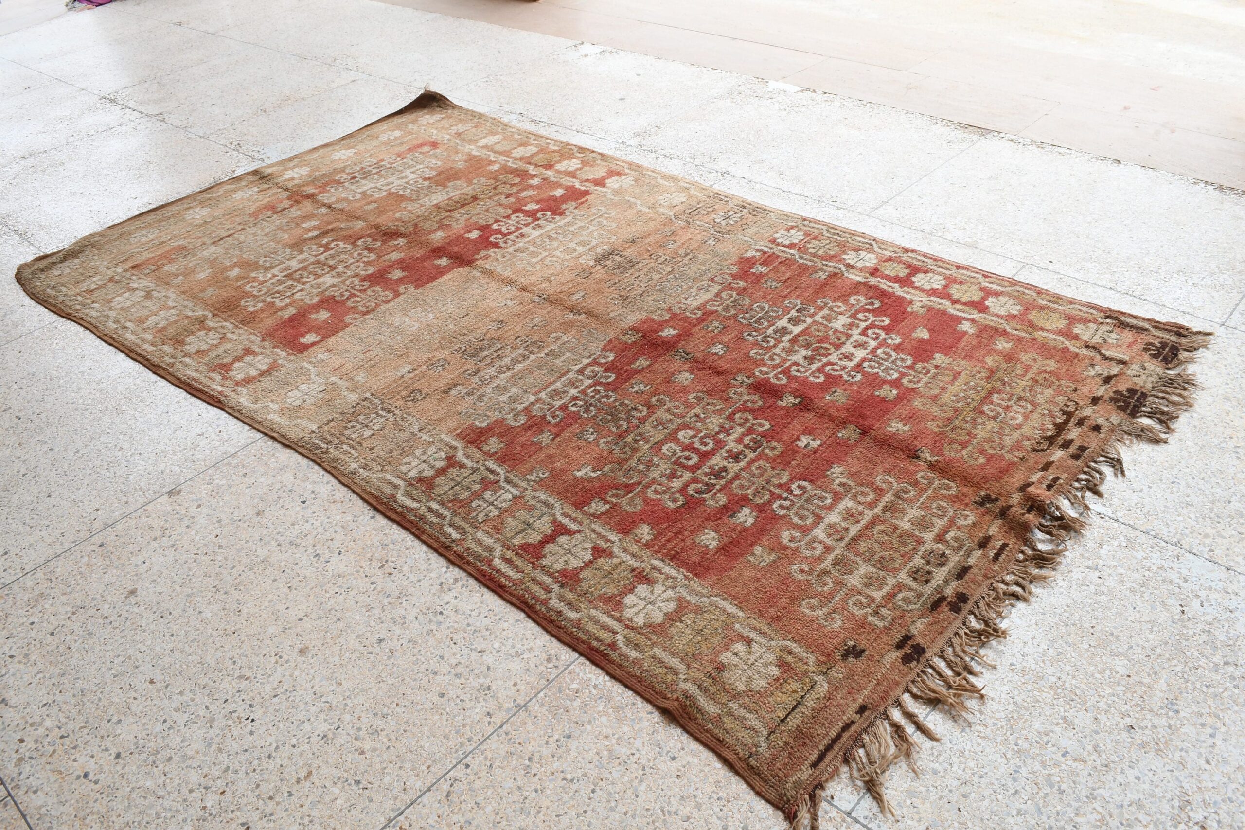 a rug with a red and beige design. il_fullxfull.6065567877_2rxo.jpg