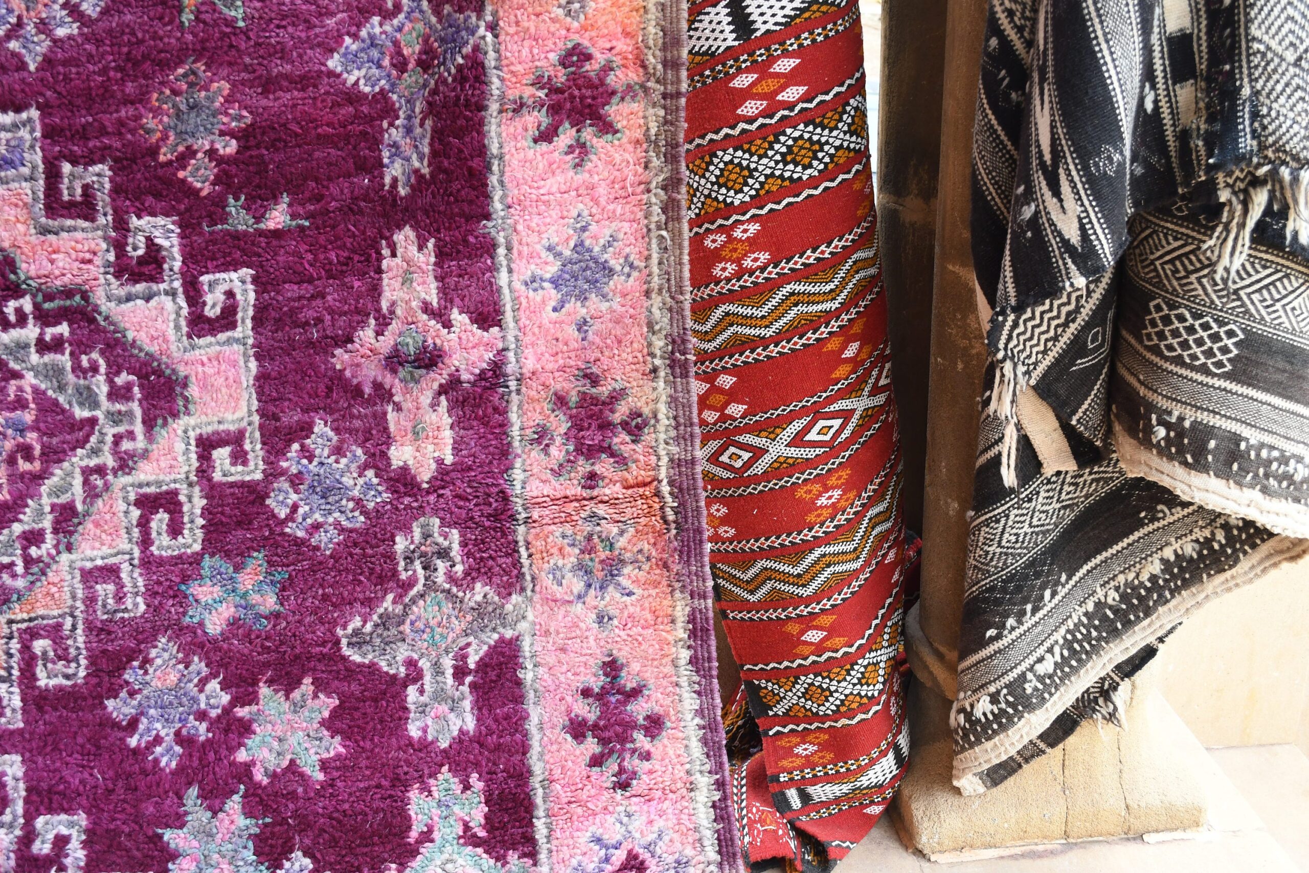 a pile of colorful rugs hanging on a wall. il_fullxfull.6065568411_ewkg.jpg