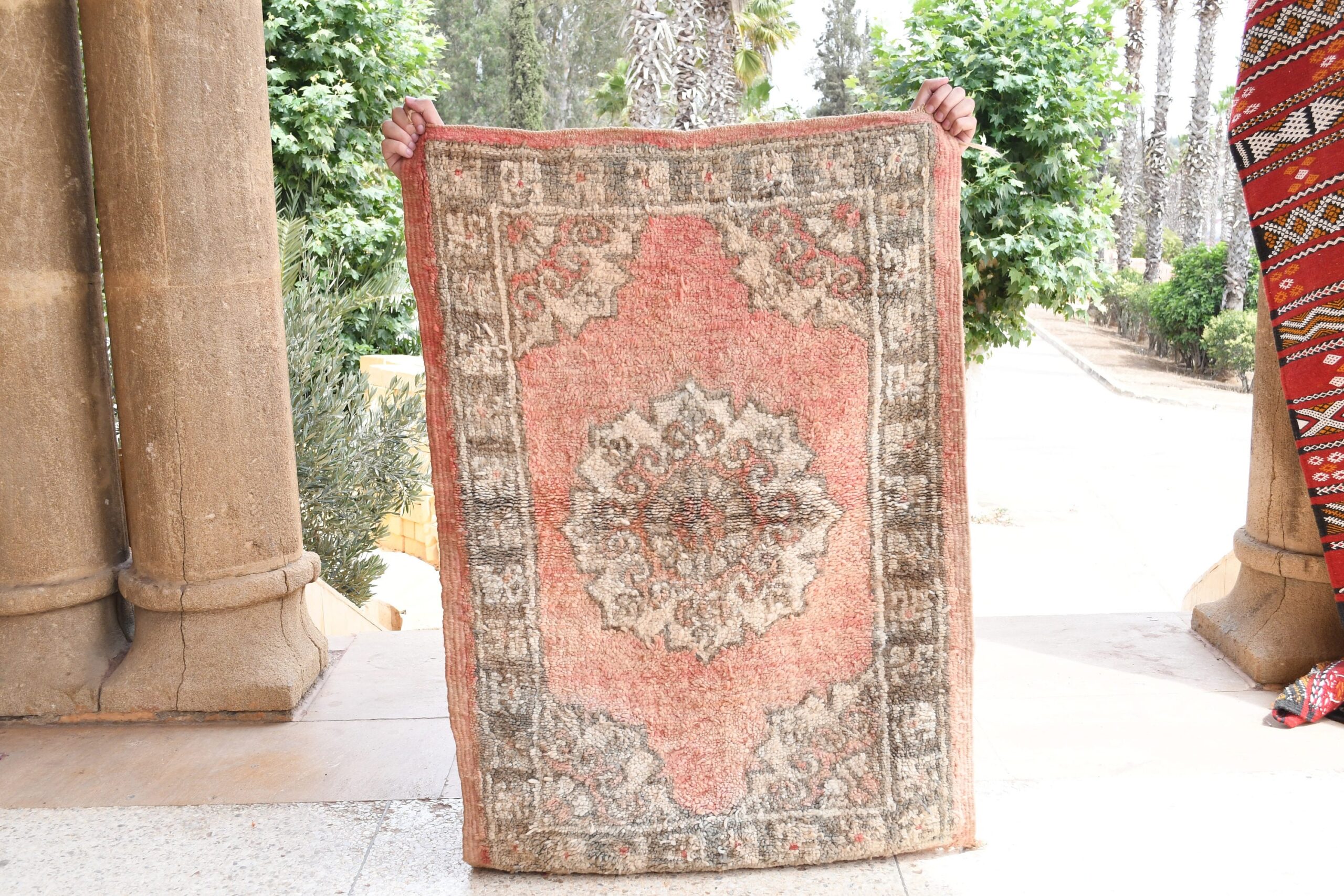 a woman standing next to a rug on a sidewalk. il_fullxfull.6065575881_zl1r.jpg