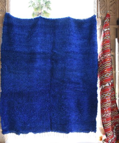 a blue rug is hanging on a wall. il_fullxfull.6065614635_k2sa.jpg