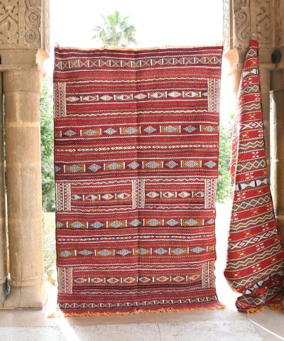 a red and white rug hanging on a wall. il_fullxfull.6065618403_o36t.jpg