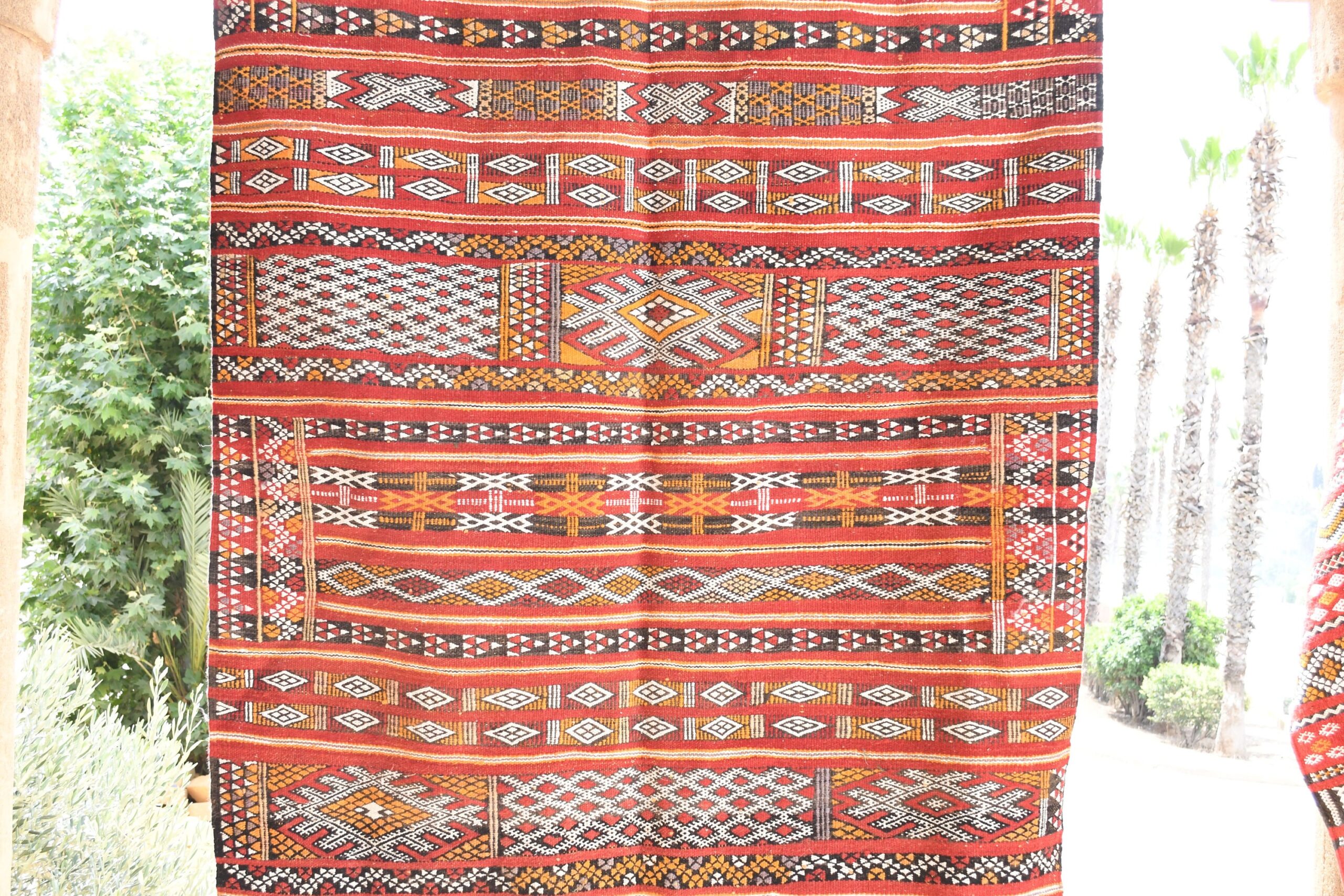 a red and black rug hanging on a wall. il_fullxfull.6065636961_v9rr.jpg