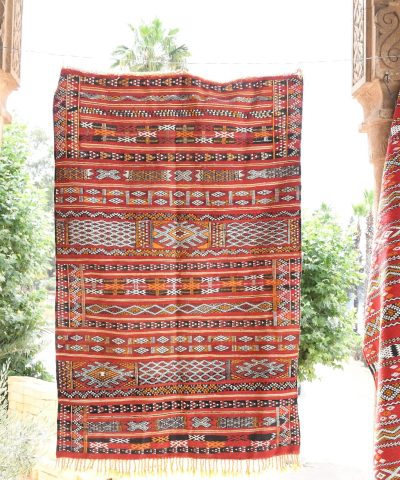 a red rug hanging on a wall. il_fullxfull.6065637625_1s98.jpg