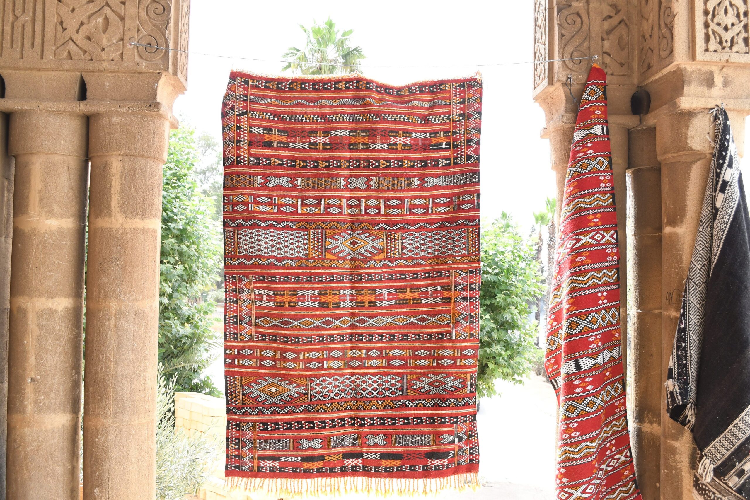 a red rug hanging on a wall. il_fullxfull.6065637625_1s98.jpg