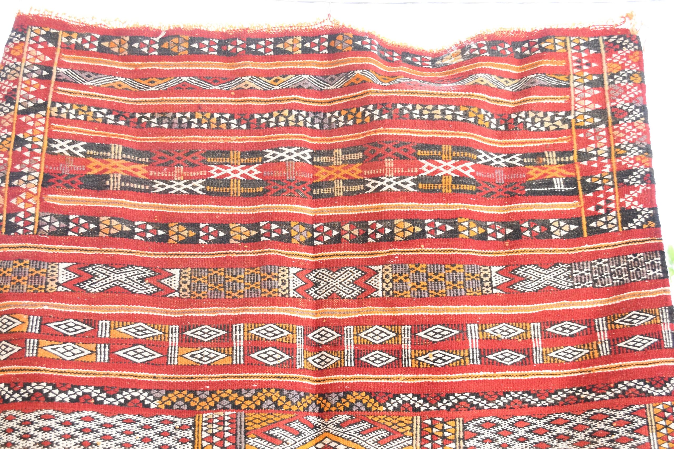 a red and black rug with a pattern. il_fullxfull.6065637835_psqy.jpg