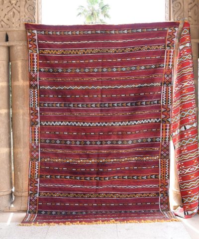 a red and black rug hanging on a wall. il_fullxfull.6065644969_c9kp.jpg