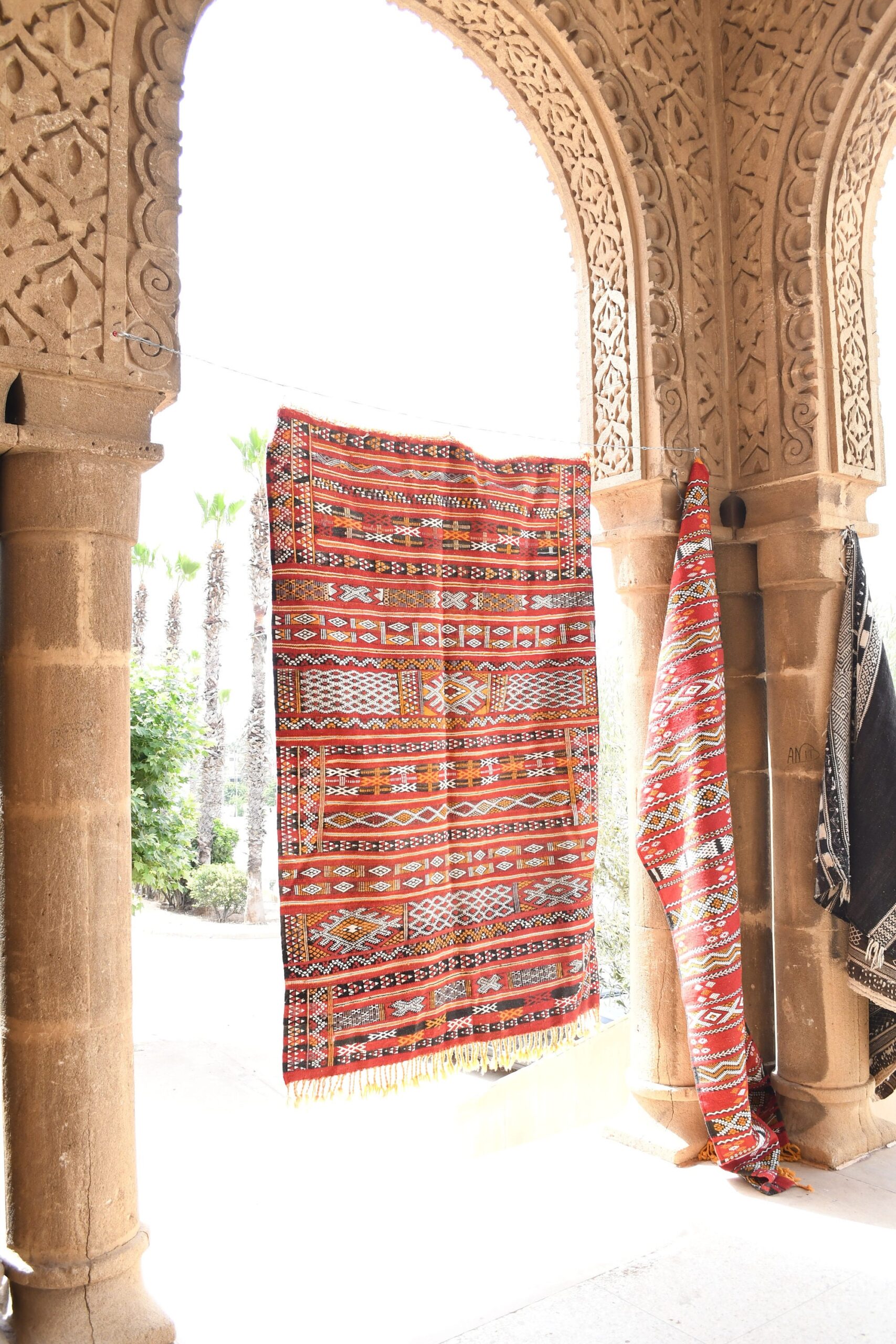 a red and white rug hanging on a wall. il_fullxfull.6069278555_oz7f.jpg