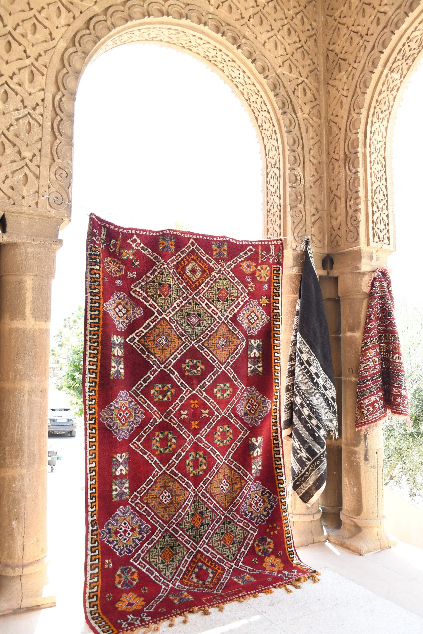 a red and black rug hanging on a wall. il_fullxfull.6069353087_5kcr.jpg