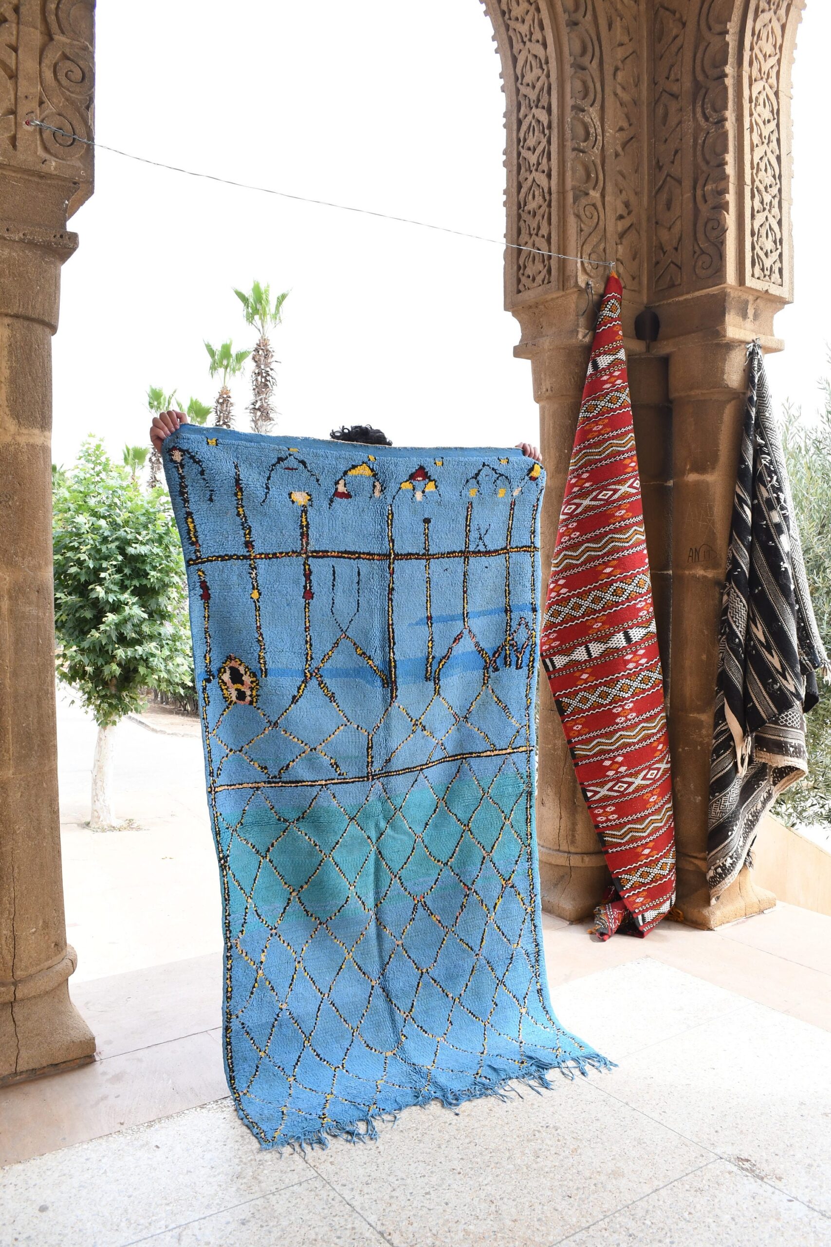 a blue bag with a red and yellow moroccan rug hanging on it. il_fullxfull.6069399703_qwdl.jpg