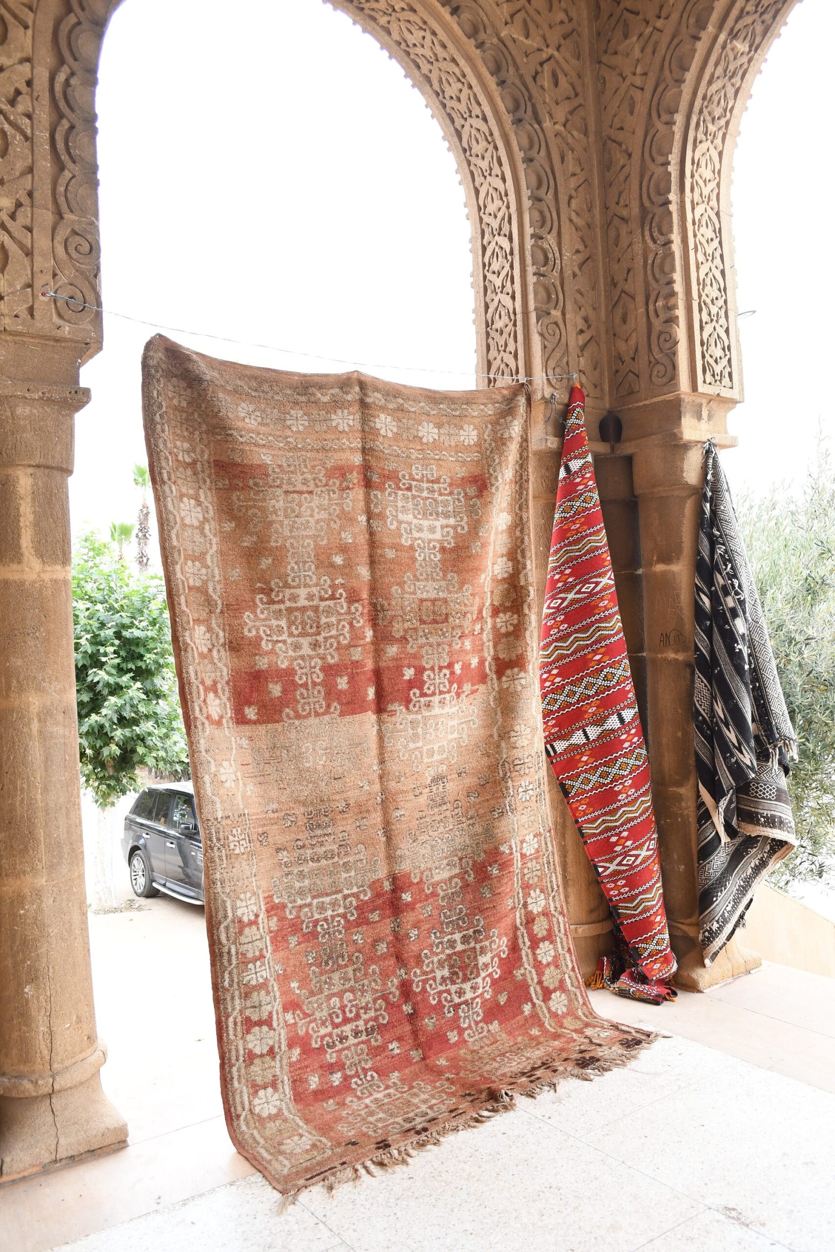 a red and white rug hanging on a wall. il_fullxfull.6069421035_p81w.jpg