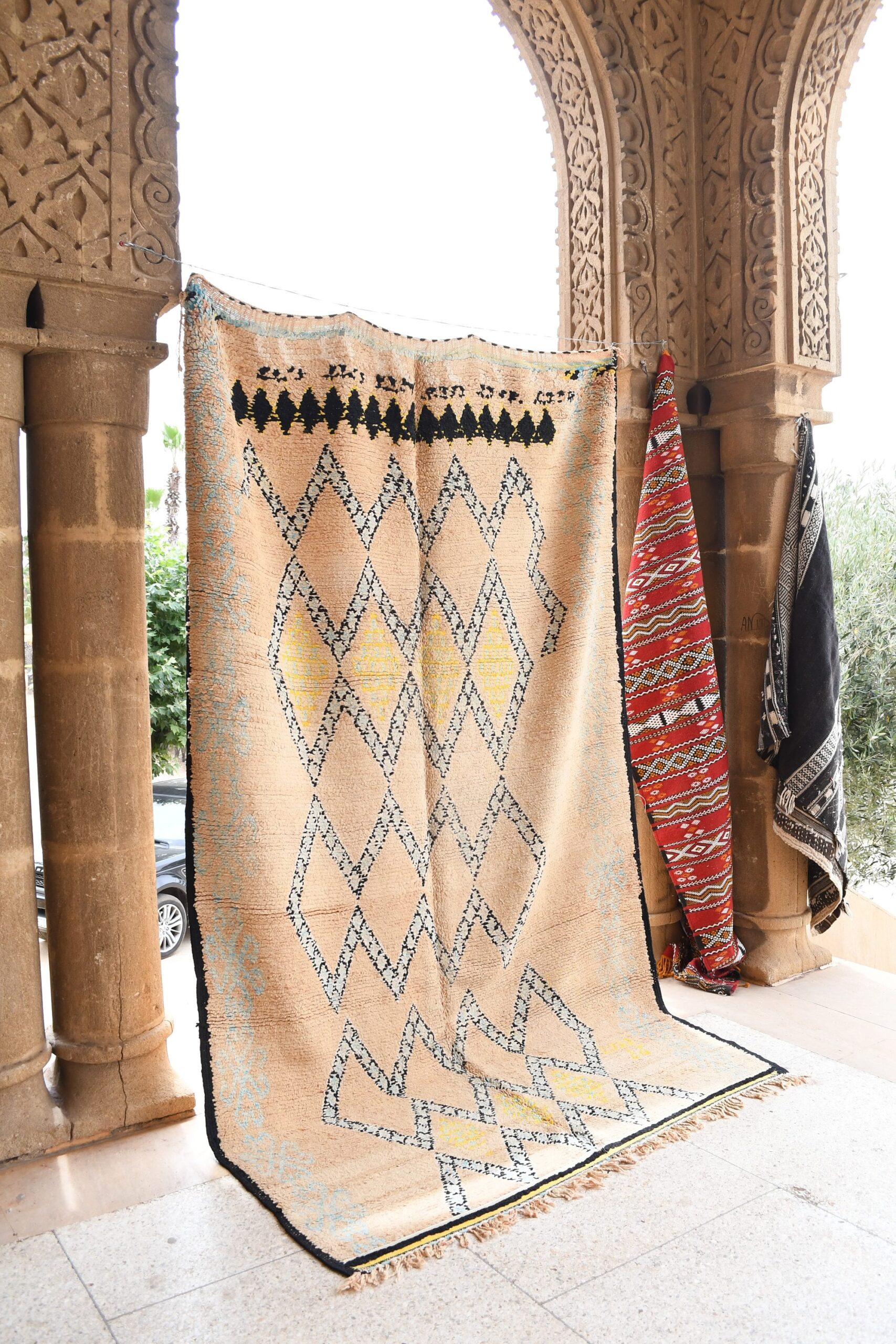 a moroccan rug hanging on a wall in a building. il_fullxfull.6071122033_owjb.jpg