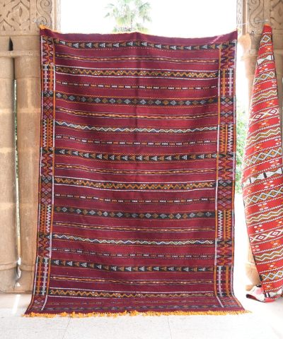 a red and black rug hanging on a wall. il_fullxfull.6071137497_81m4.jpg