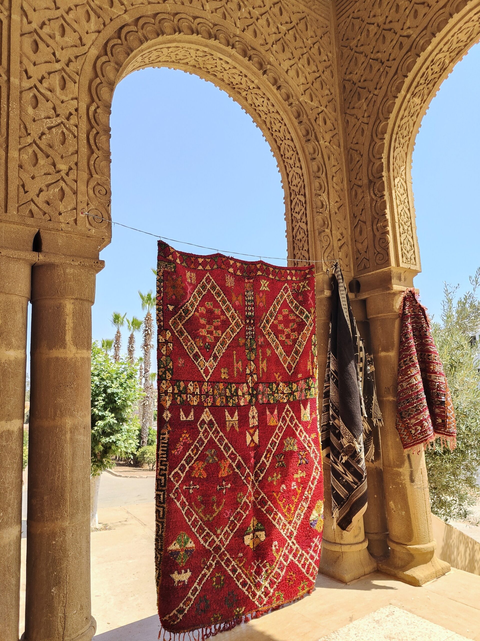 a red rug hanging on a wall. il_fullxfull.6071167149_ghqy.jpg