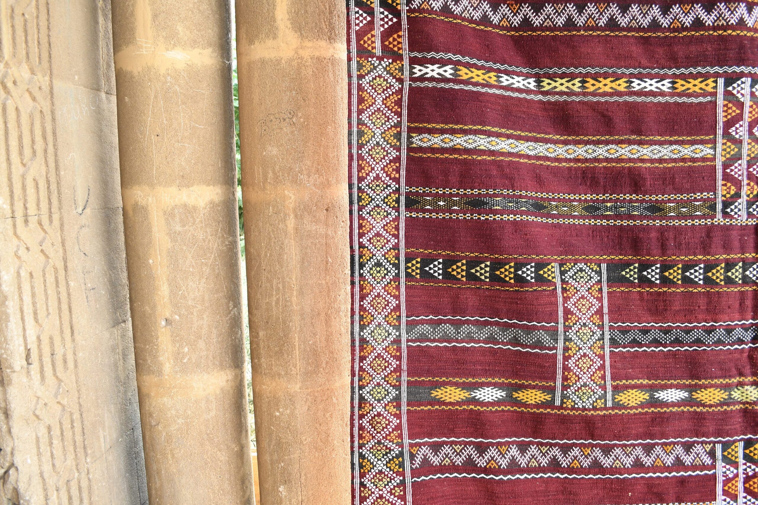 a red rug hanging on a wooden pole. il_fullxfull.6073922775_3ffh.jpg