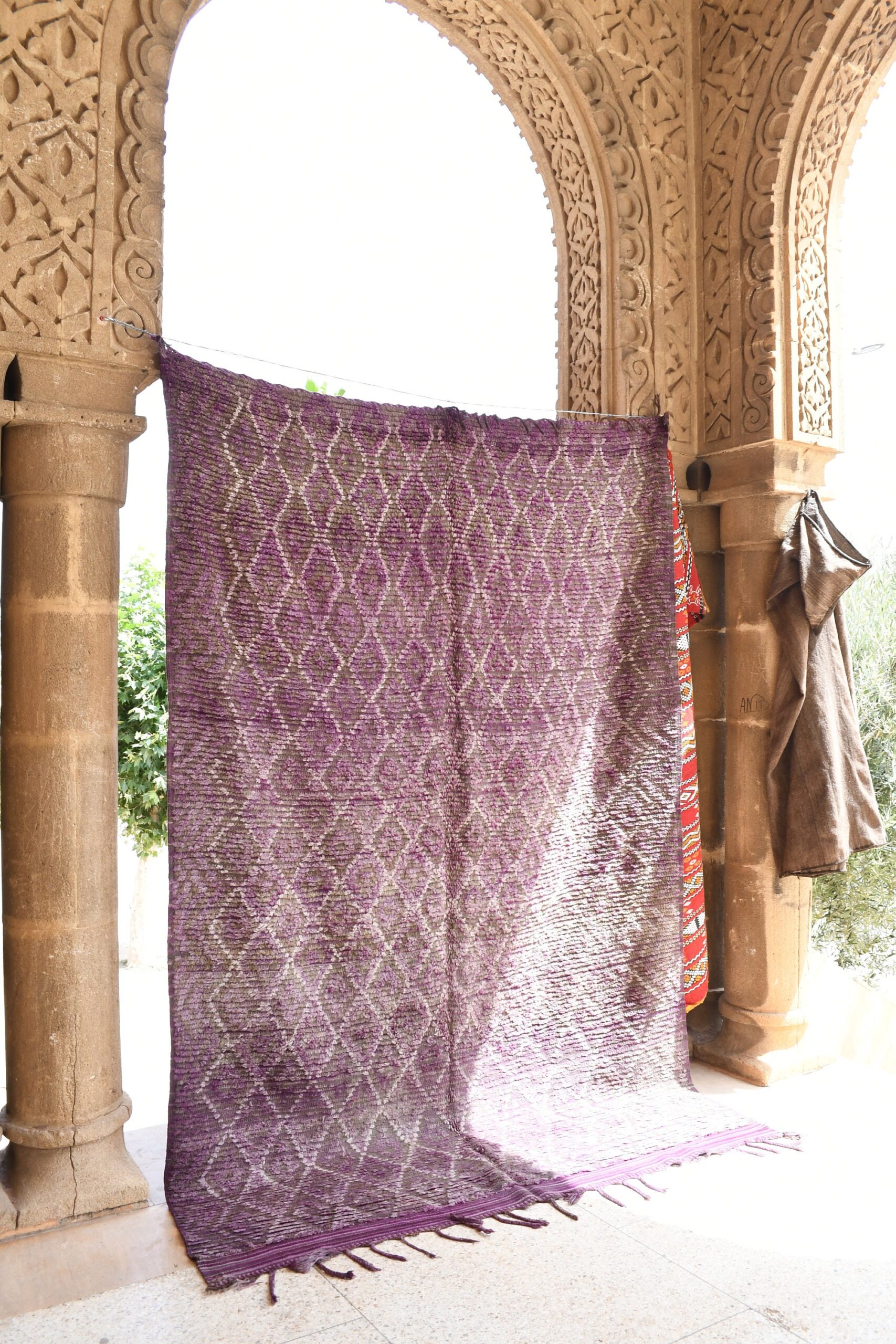 a purple and white rug hanging on a wall. il_fullxfull.6073957209_iih1.jpg