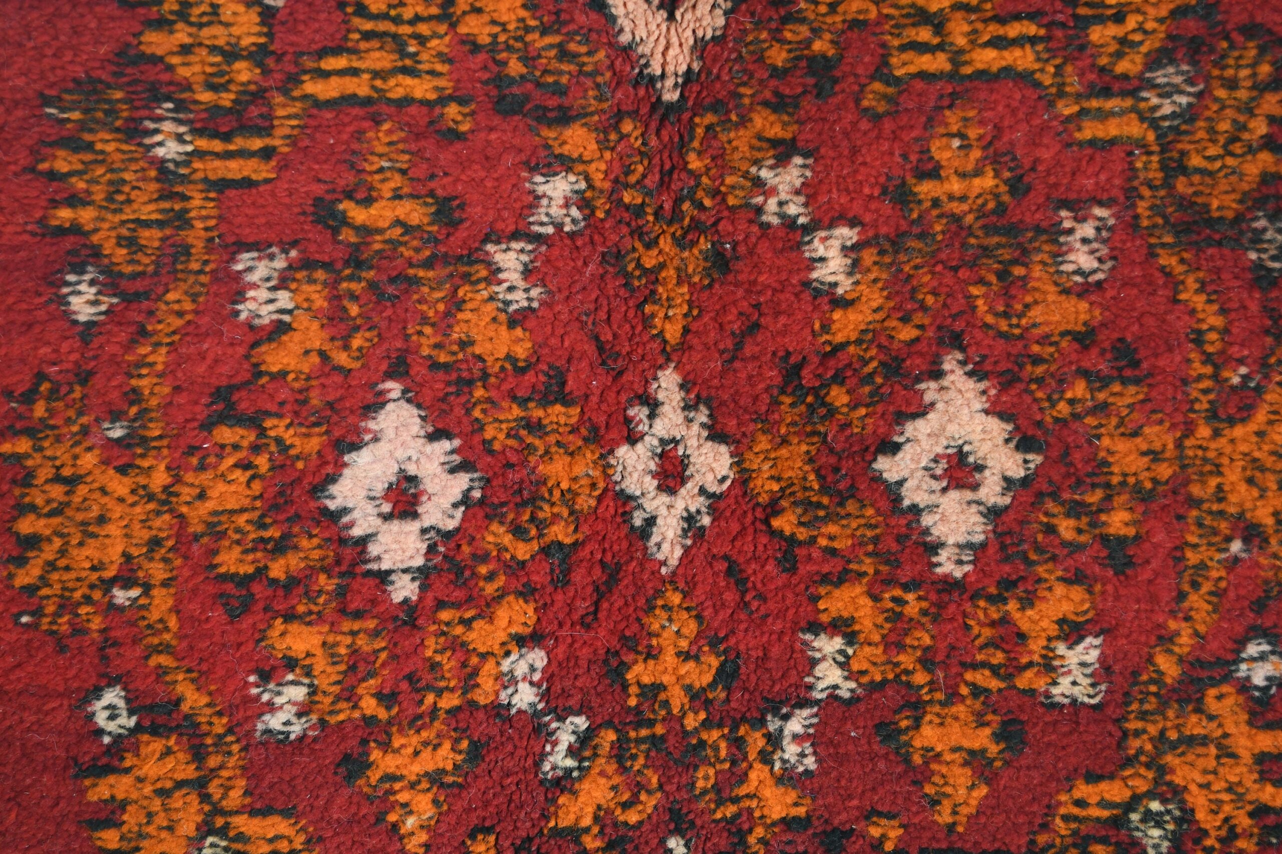 a red rug with a pattern of flowers. il_fullxfull.6076125329_djfh.jpg