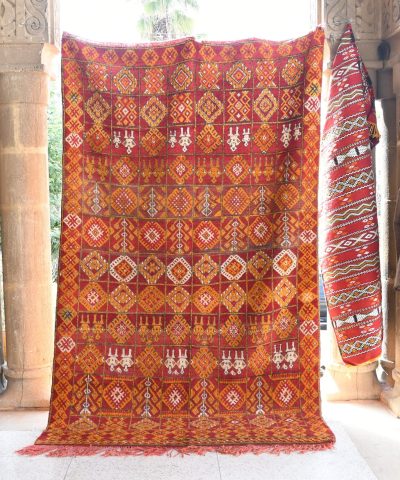 a red and orange rug hanging on a wall. il_fullxfull.6076129737_s2uj.jpg