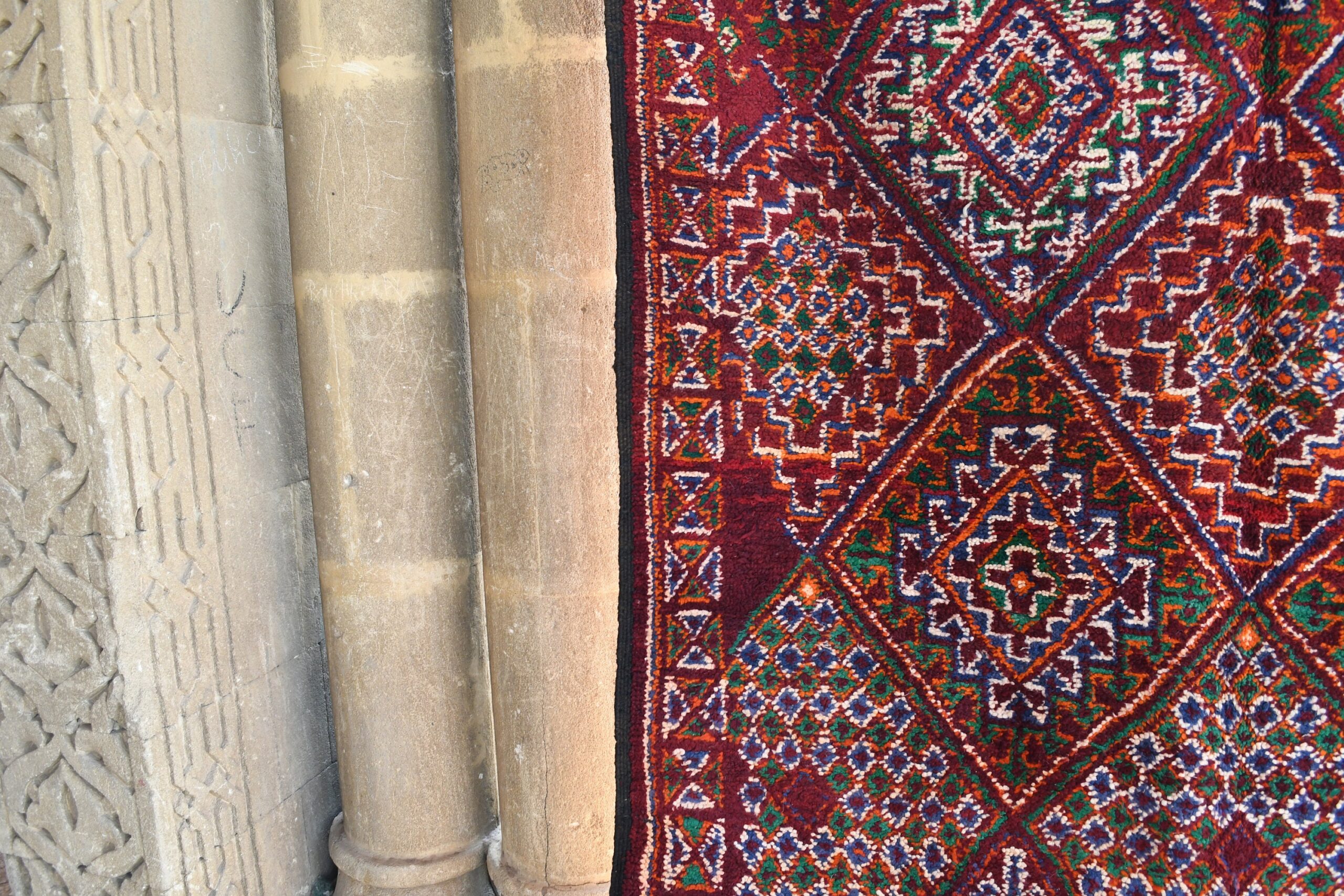 a red rug on a stone wall. il_fullxfull.6076133007_lcos.jpg