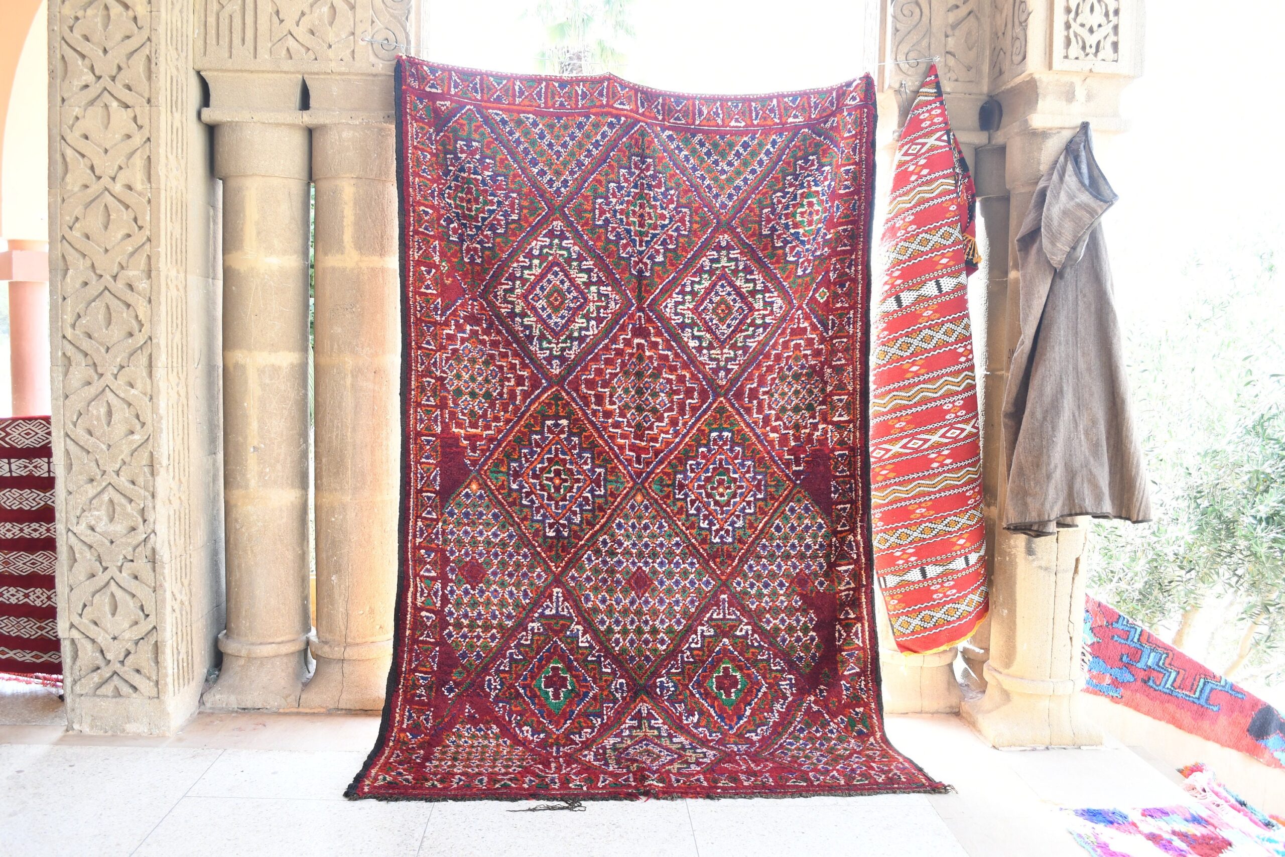 a red rug hanging on a wall. il_fullxfull.6076133525_abkz.jpg