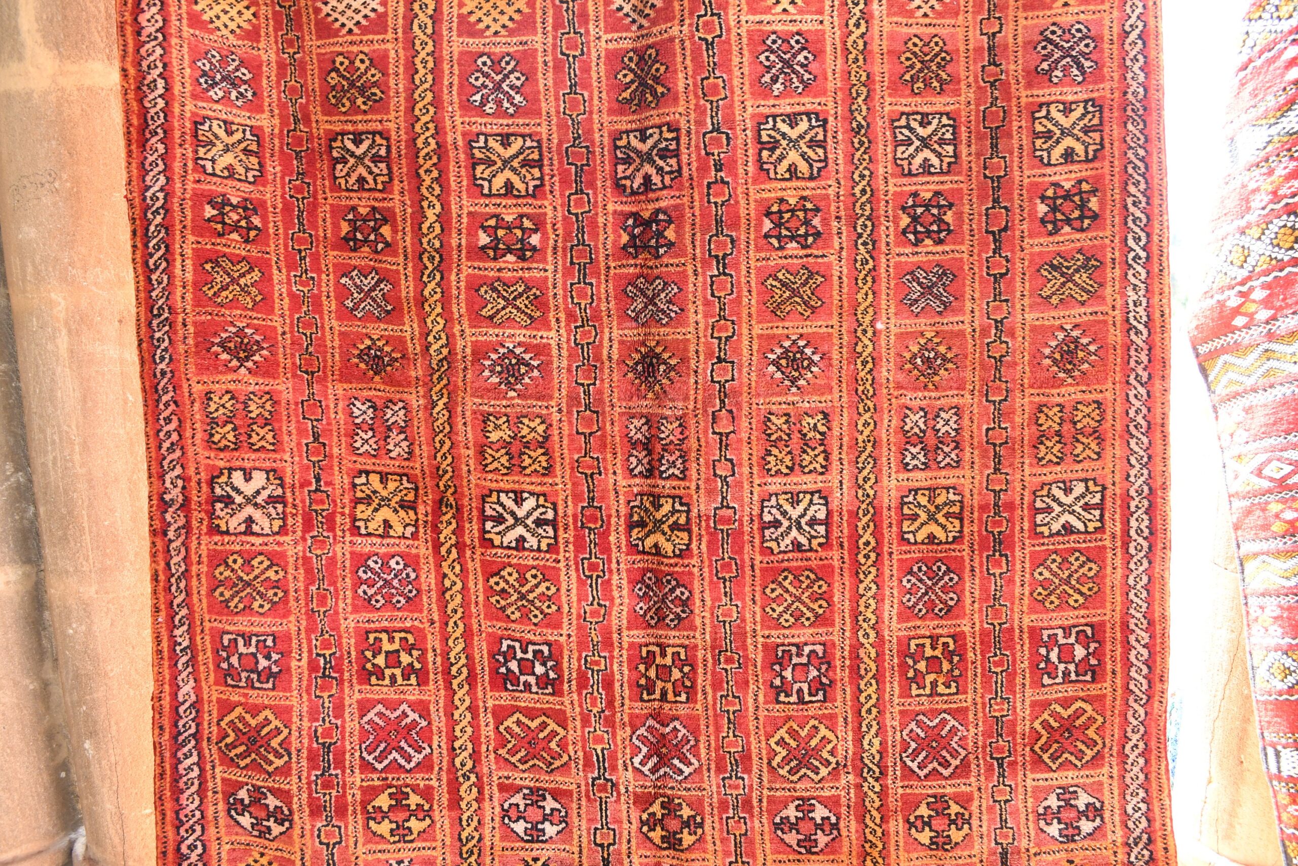 a red rug with a pattern on it. il_fullxfull.6076136023_5865.jpg