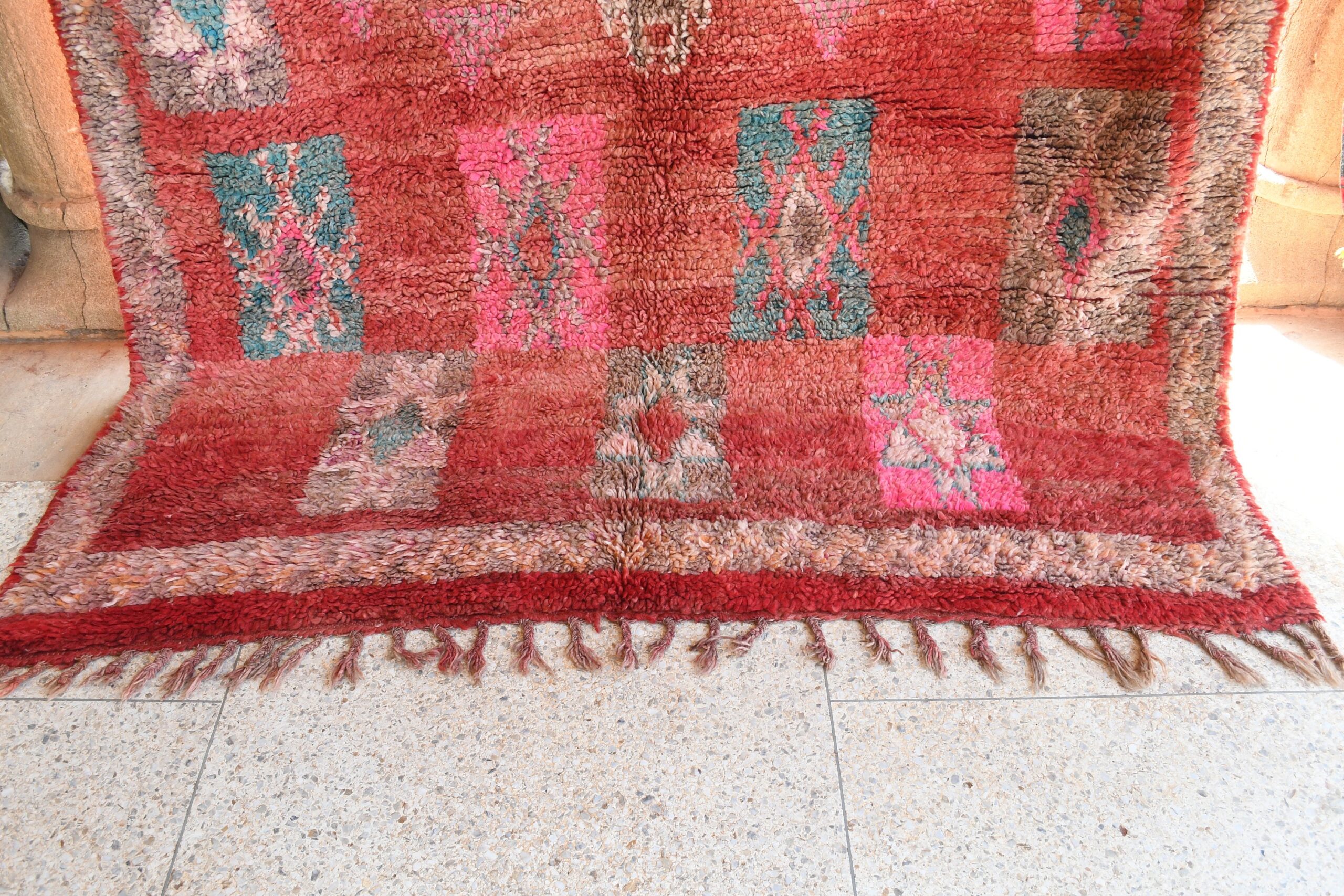 a red rug with a pattern of flowers. il_fullxfull.6076138849_7l7k.jpg