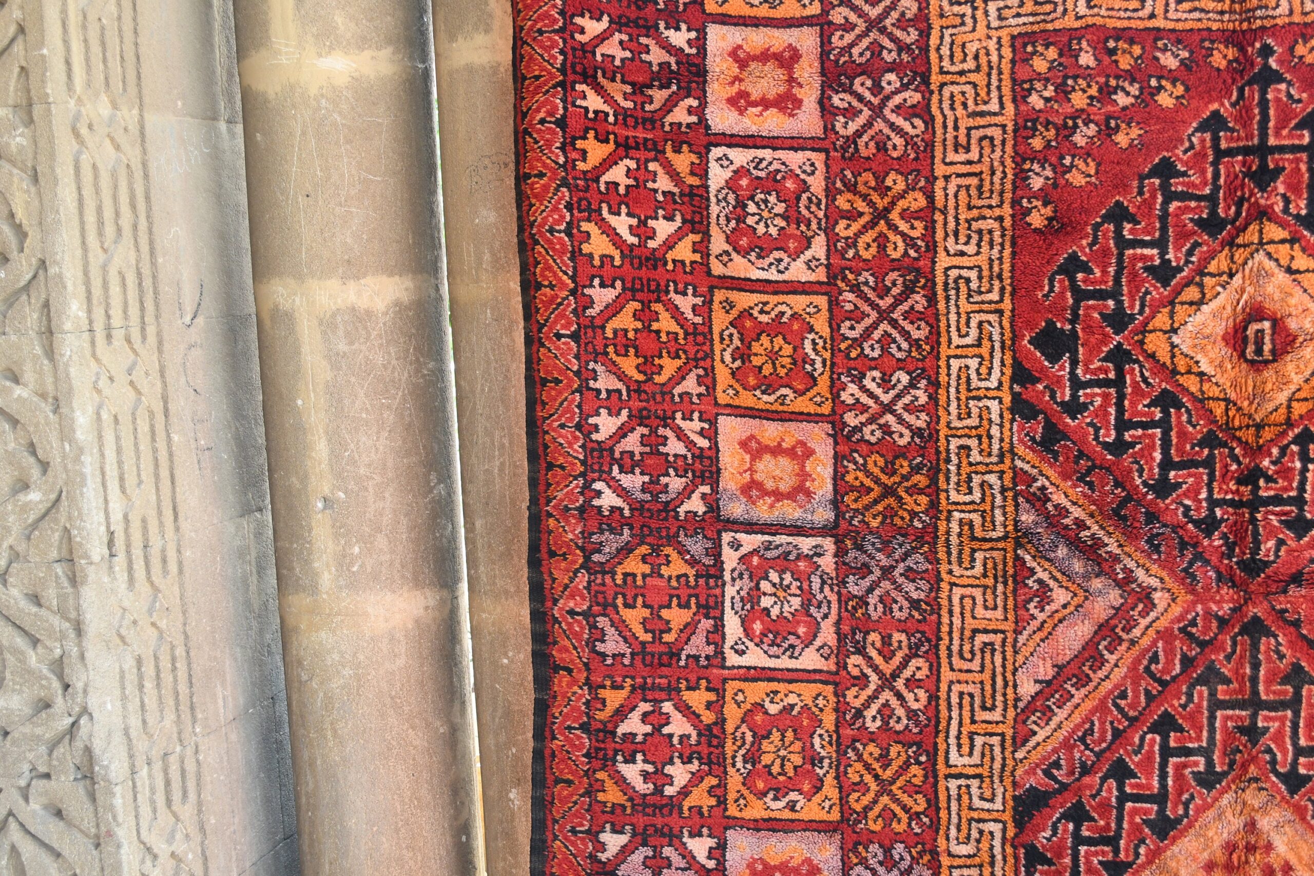 a red rug with a pattern on it. il_fullxfull.6076141939_56ty.jpg