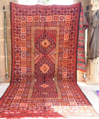 a red rug is on display in a room. il_fullxfull.6076142569_r1o3.jpg