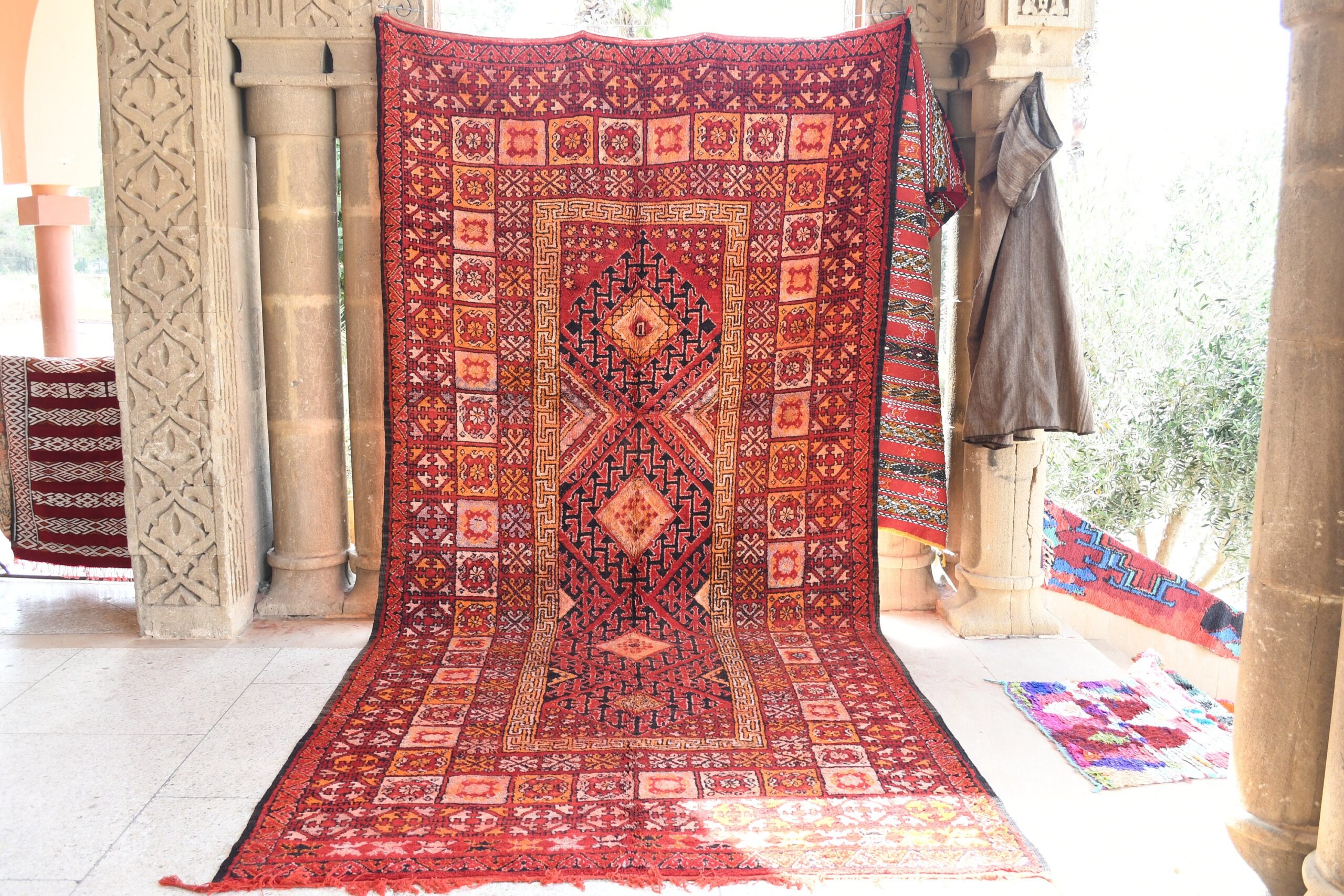 a red rug is on display in a room. il_fullxfull.6076142569_r1o3.jpg