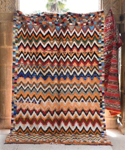 a colorful rug is hanging on a wall. il_fullxfull.6076150931_mbcz.jpg