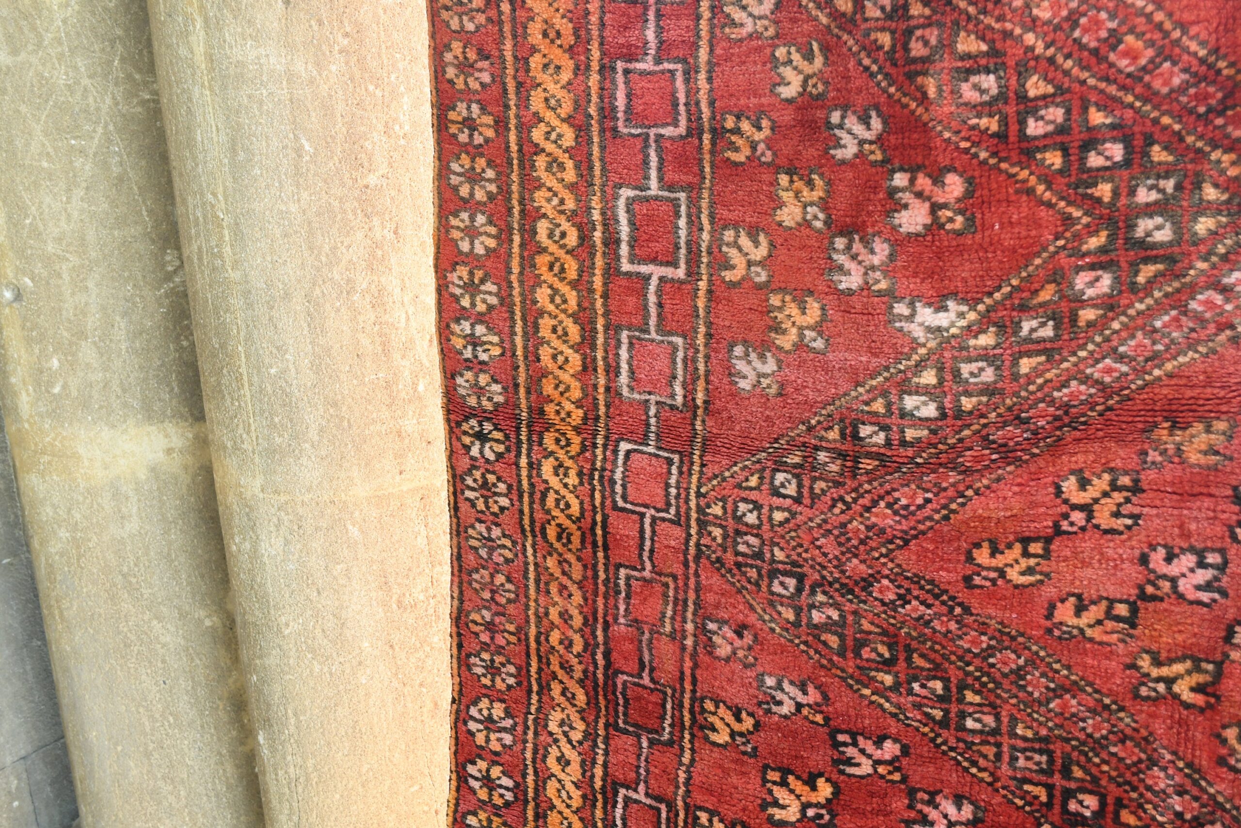 a red rug with a pattern on it. il_fullxfull.6076153045_38c1.jpg