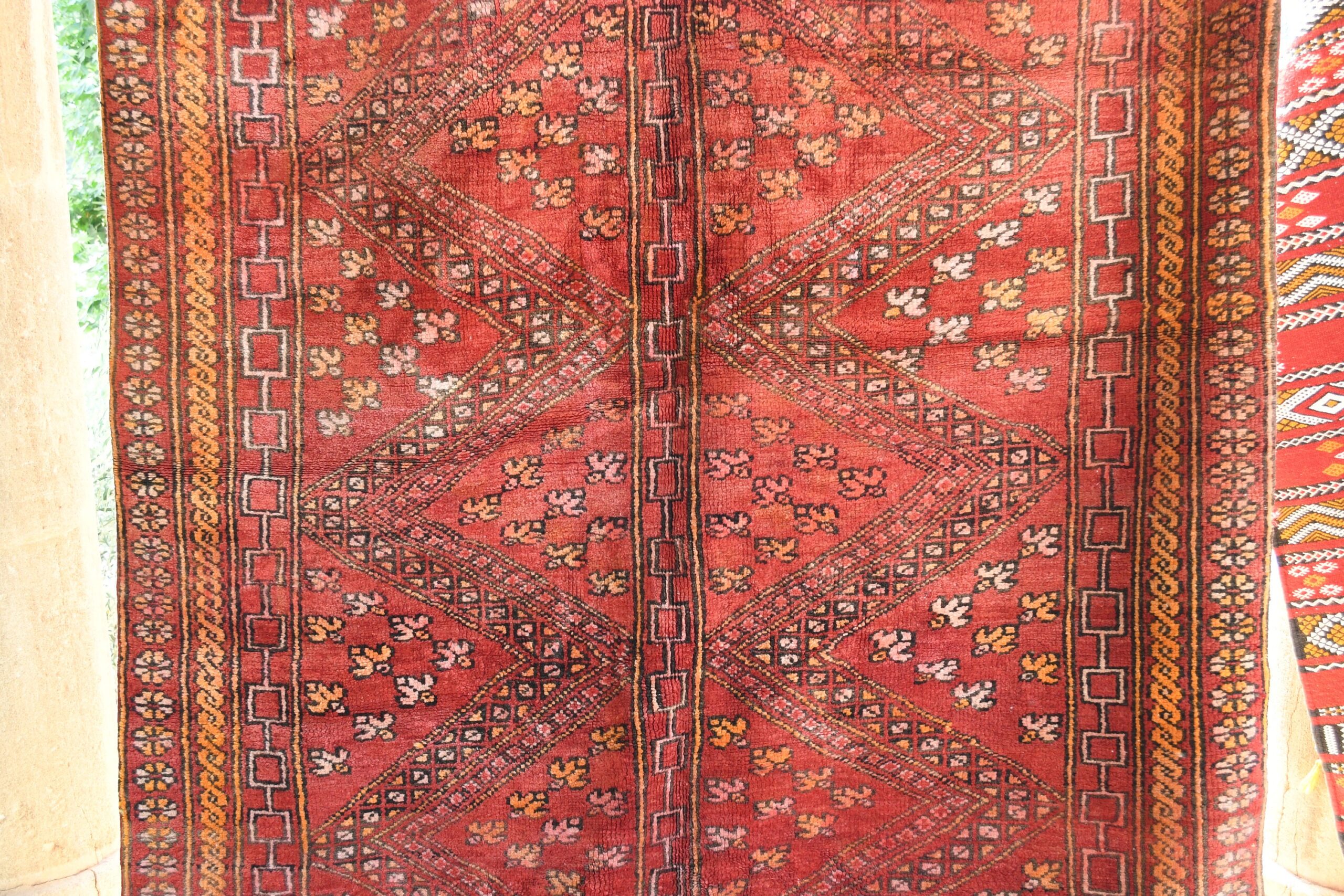 a red rug with a pattern on it. il_fullxfull.6076153209_tflu.jpg